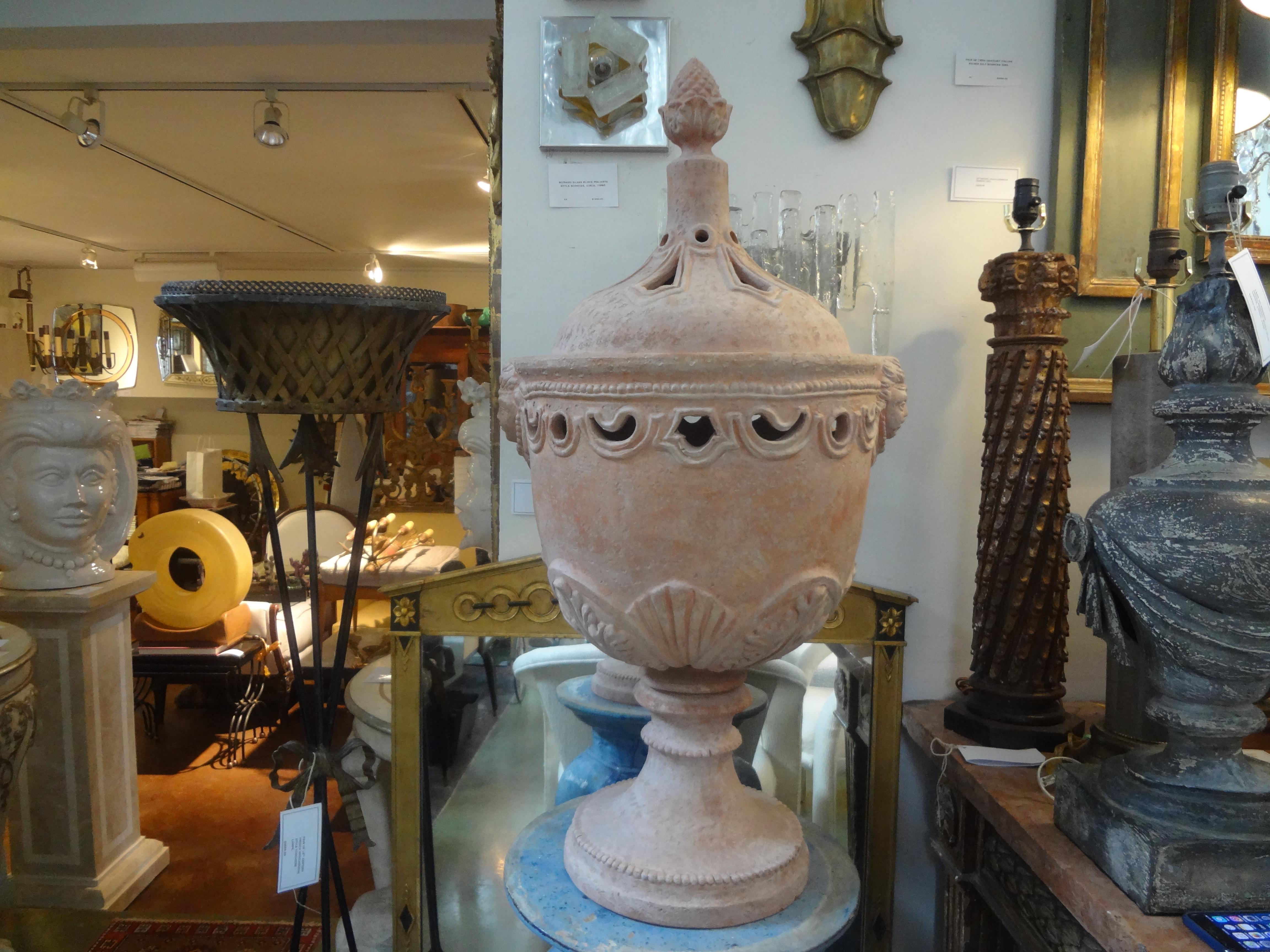 Monumental pair of Italian neoclassical 18th century style terracotta urns by Galestro. These stunning Tuscan garden urns with pierced openings and adorned with masks, great indoors or outdoors. The lids come off and urns can be used as jardinieres
