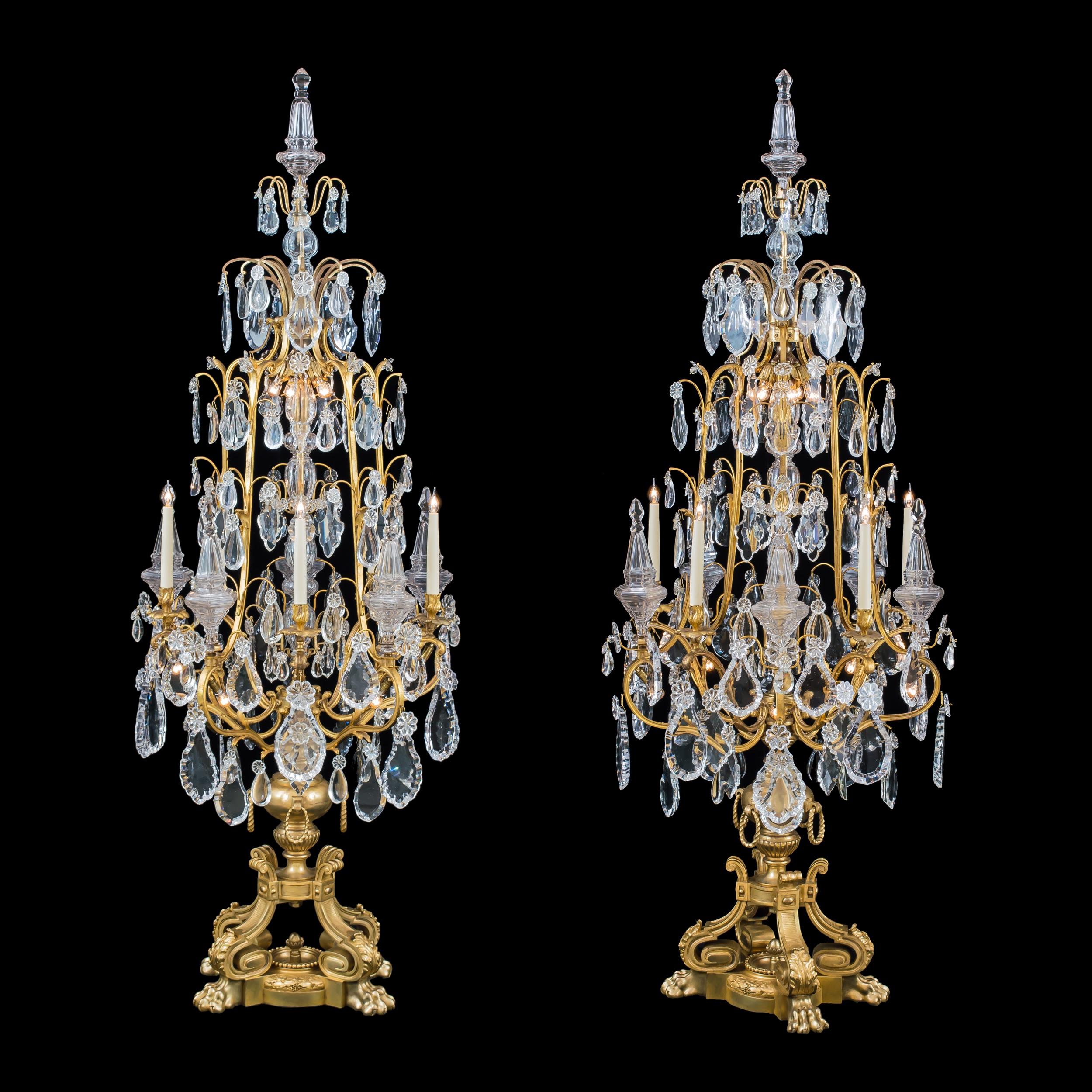A magnificent pair of Louis XV style
Ormolu and crystal girandoles
Probably by Baccarat

Constructed from finely cast and chased ormolu, the imposing floor candelabra—almost 2-meters tall—are supported on four lion’s paw feet surrounding a
