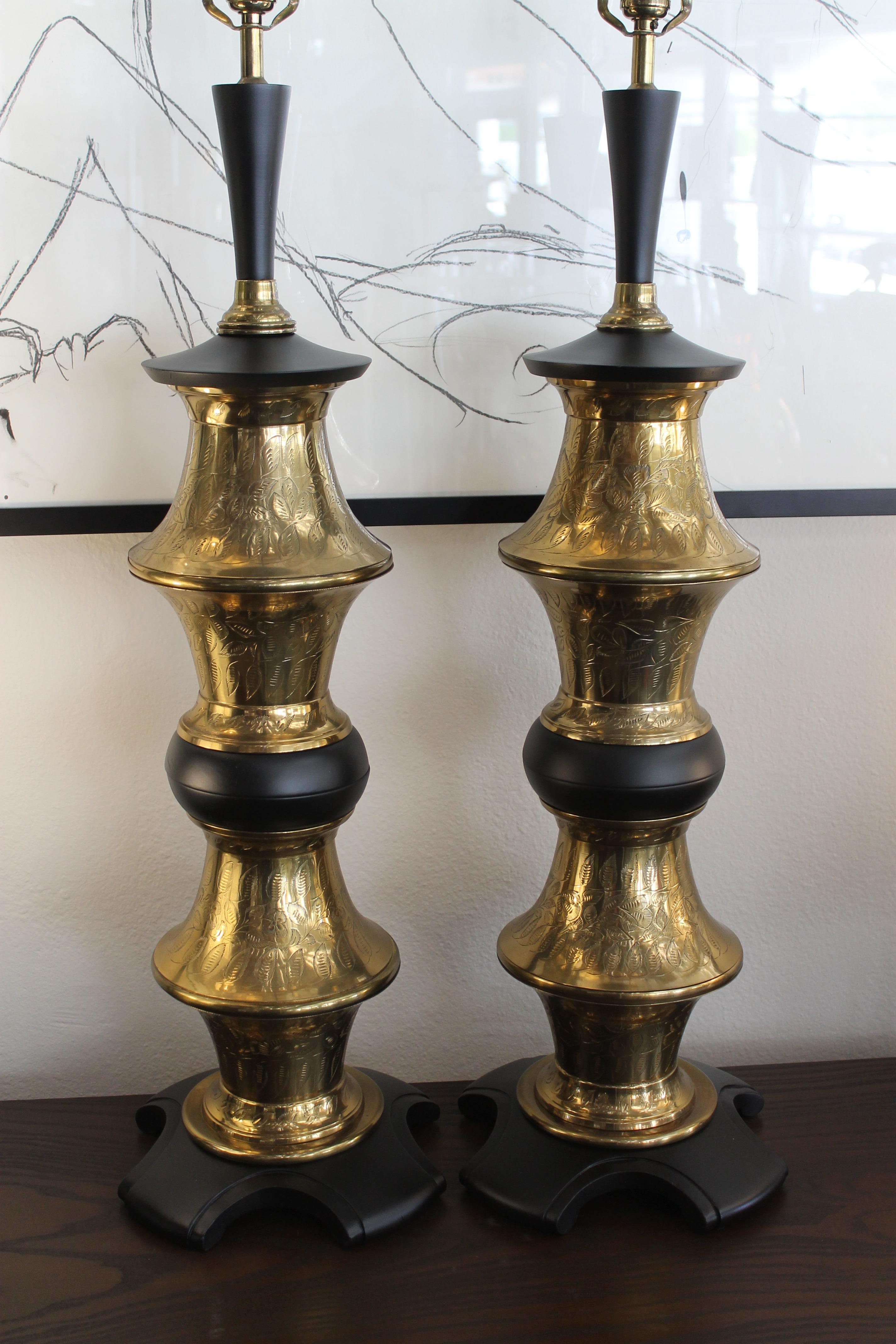 Pair of Moroccan style lamps with engraved brass. Each lamp measures 33.5