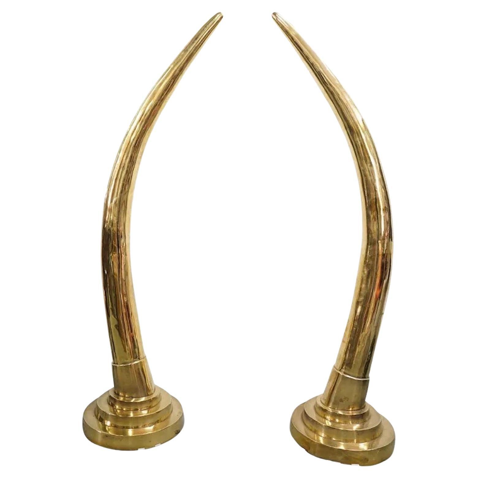 Amazing pair of life-sized polished cast solid brass faux elephant tusks mounted to tiered round brass stands, attributed to Suzanne Dahl and Jerry Barich from their Versailles Collection, Kilimanjaro Series, 1981.
Very rare to find in brass as