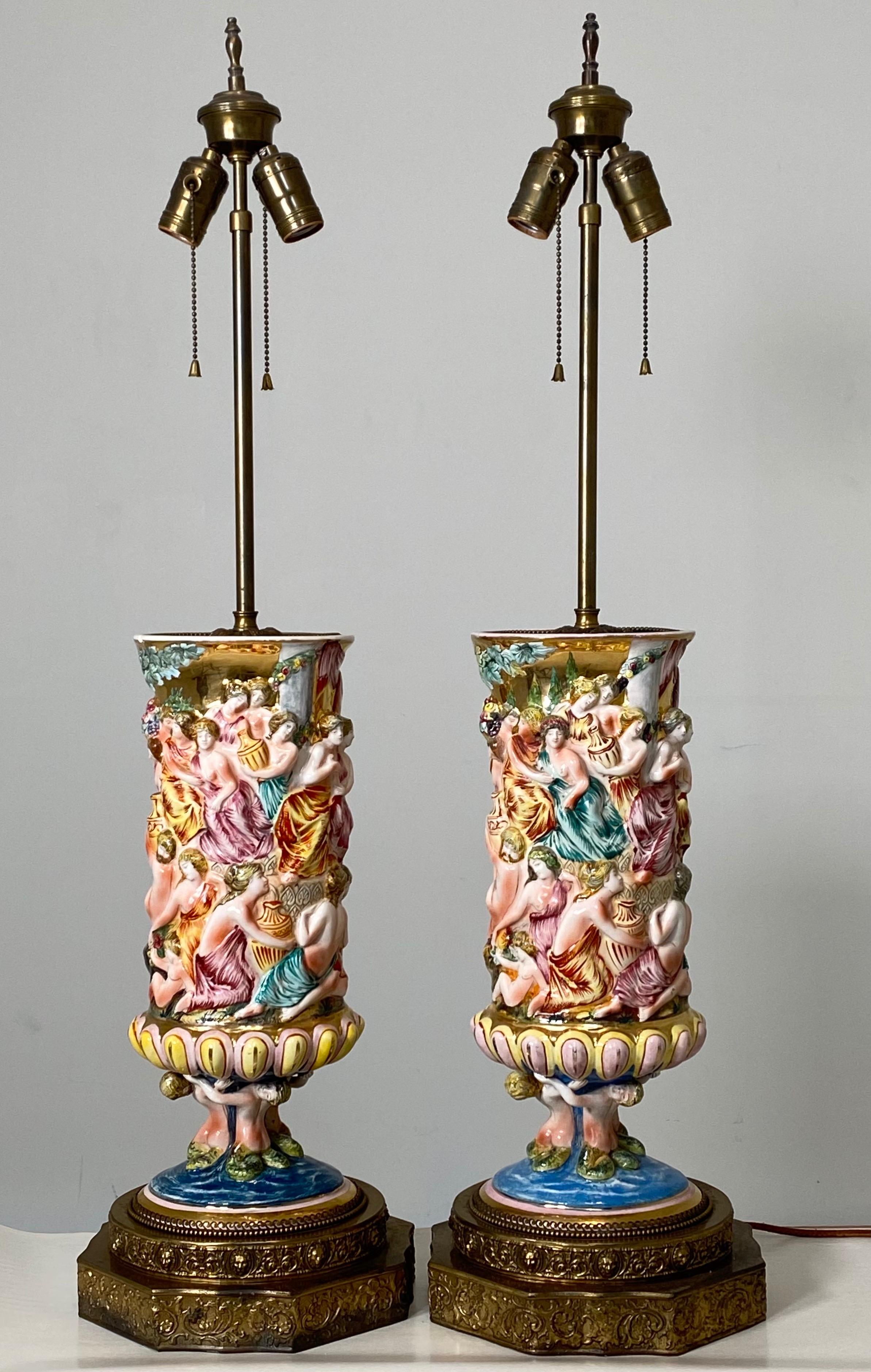 Large and uncommon Capodimonte. Produced between 1920 and 1950. Each lamp measures 35” tall, 9” wide and 8” deep. The ceramic porcelain component are each 16” tall, 6” deep and 7” wide. A rare pair to have. Each piece has a slightly different hand