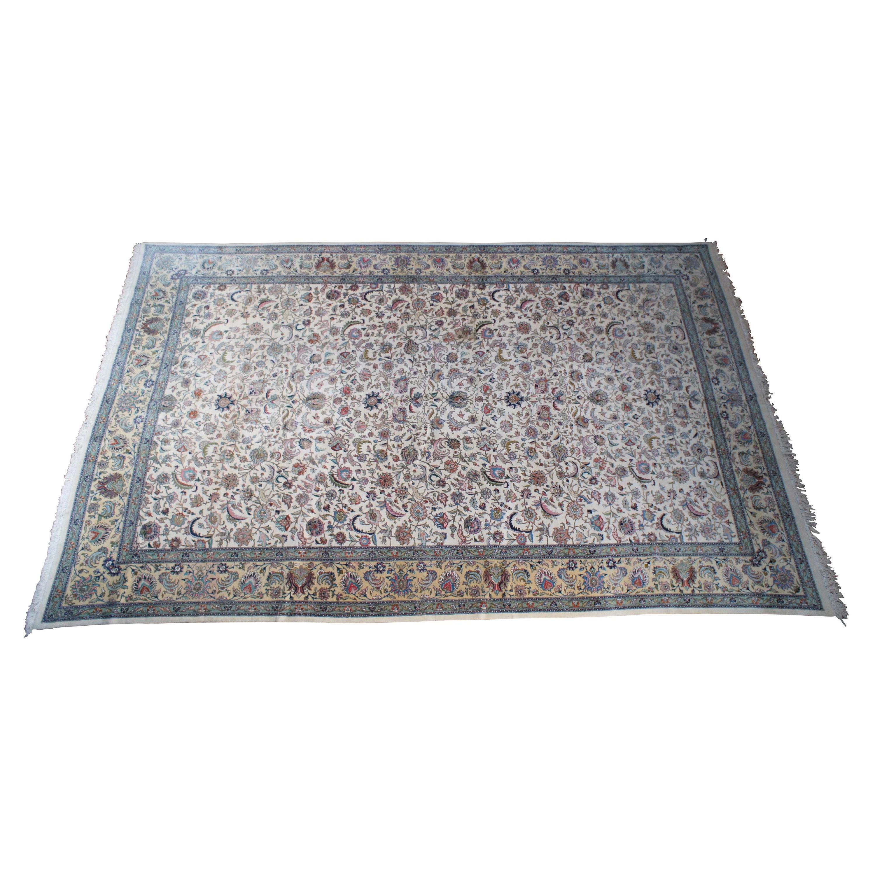 A large and impressive 100% wool pile area rug featuring a floral scene with animals (Deer, Birds) on a beige field with pinks, greens, browns, reds, tans, blues and greens.  

Located in the northwestern region of Iran, Tabriz is a city steeped in
