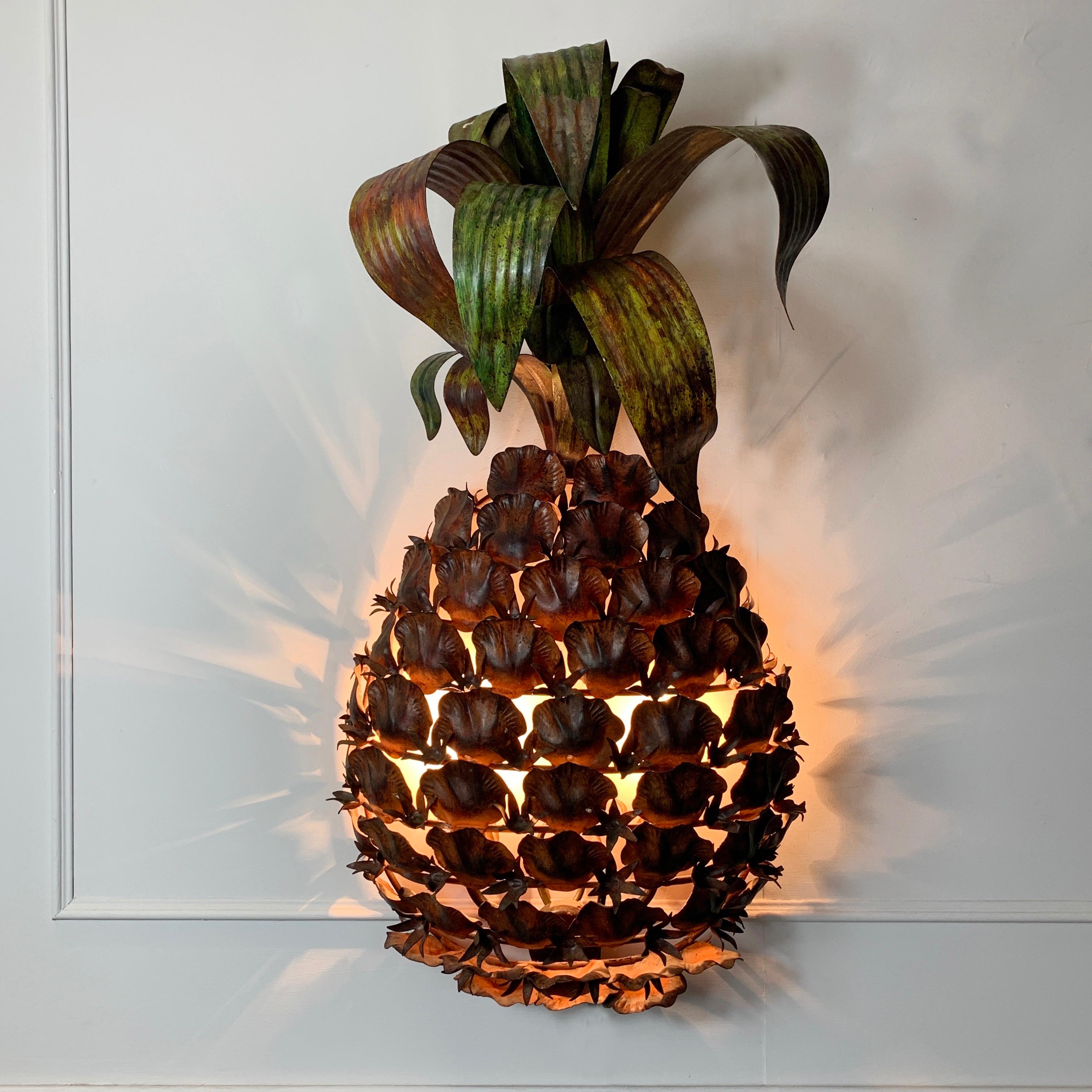 Monumental pineapple wall sconce
Italian/French origin, circa 1960s
Huge metal toleware pineapple wall sconce with 2 bulb holders hidden behind
Individually crafted metal pieces are built up to create the multi brown toned body, adorned with a