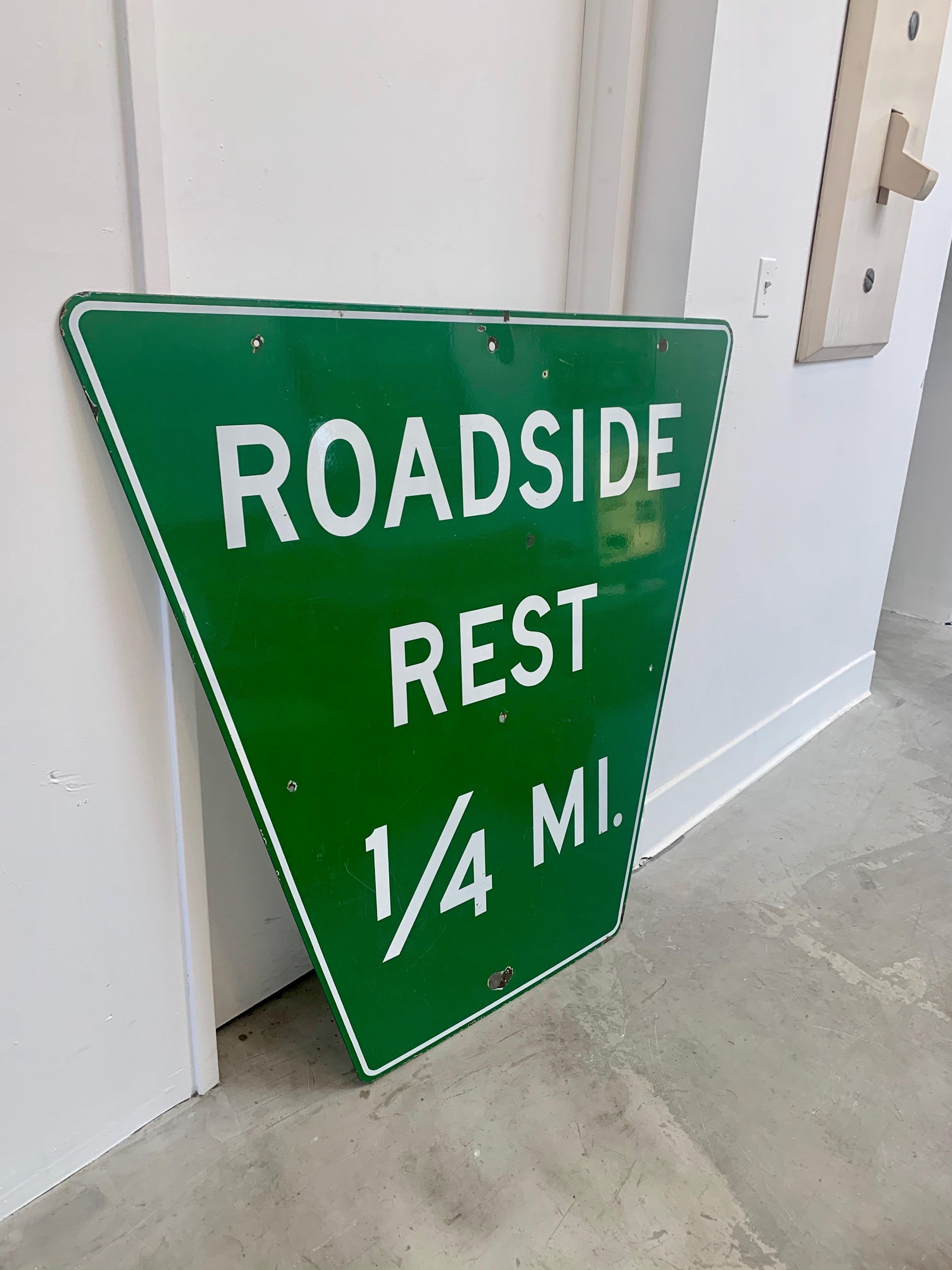 Super rare vintage porcelain highway sign. Great green coloring with white lettering. Retired highway sign letting drivers know there is a place to pull over and rest a quarter mile ahead. Bygone sign and cool piece of transportation Americana. Sign