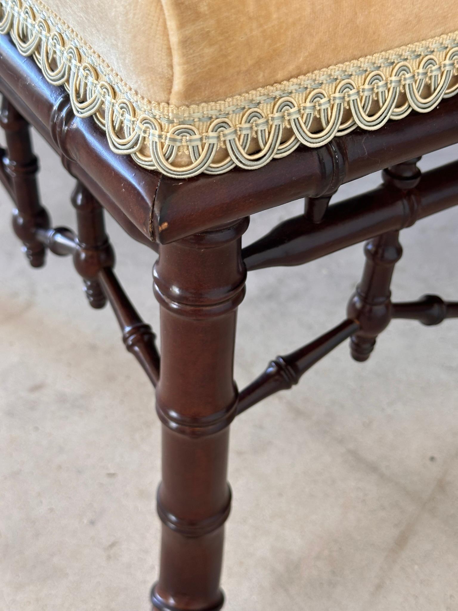 This stunning large faux bamboo ottoman by Century Furniture exudes elegance and sophistication.
The beautifully crafted wooden base mimics the look of bamboo, providing a touch of exotic charm. Topped with plush velvet fabric in a soft, luxurious