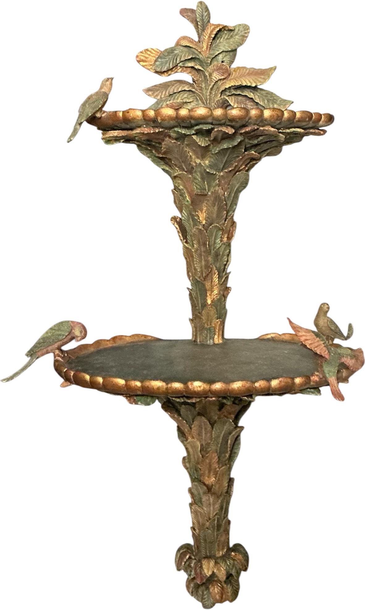 This is a pair of very large regency style cast palm frond wall shelves with attached birds. The shelves are cast resin / composition and are very heavy. There are two surfaces for display pieces. They date to the 1980s and are unmarked. These might