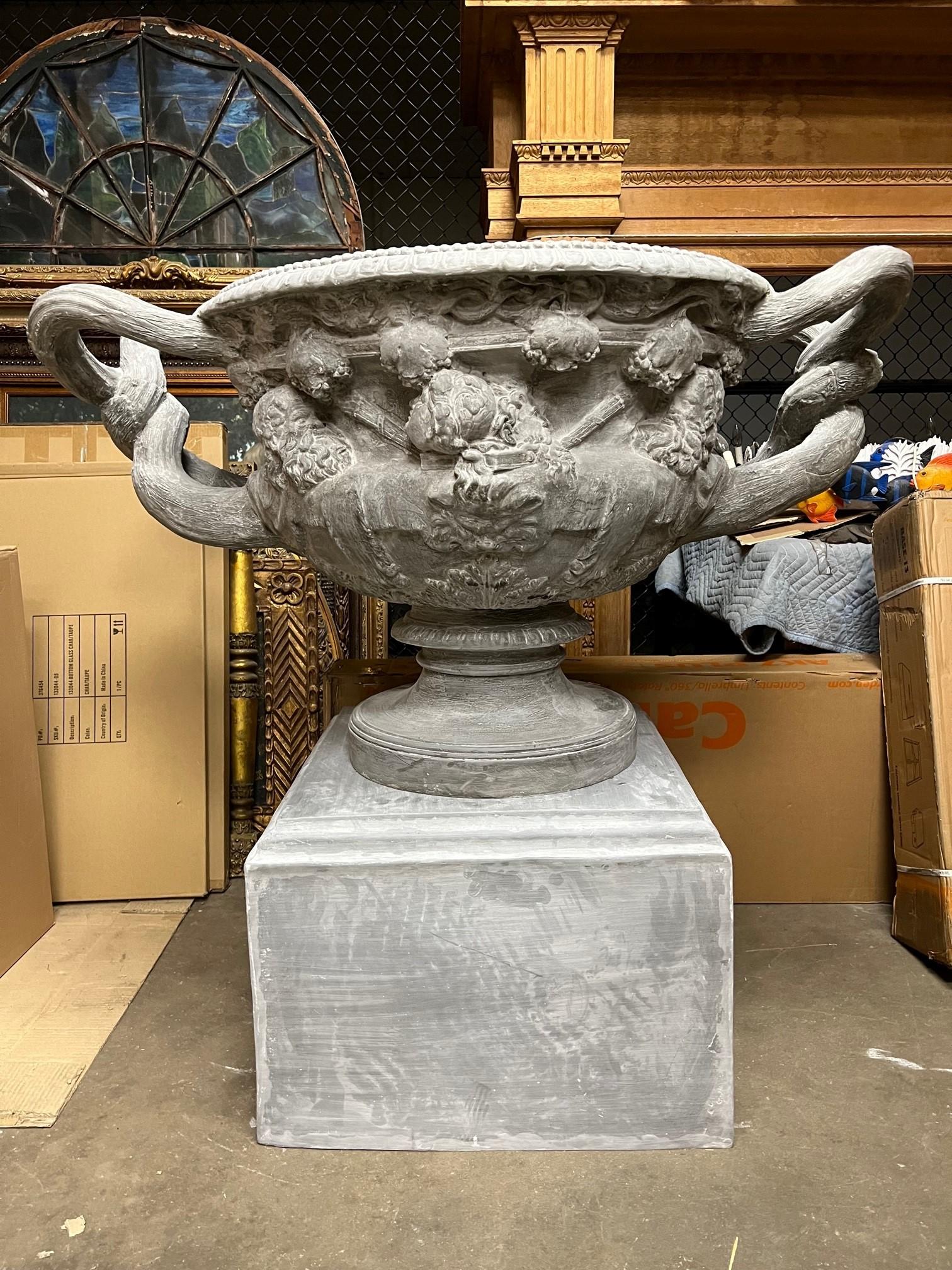Fabulous Large fiberglass handle urn and pedestal, a reproduction from a vintage terracotta urn and pedestal. I have the original terracotta urn and pedestal also available on 1stDibs for $14,000 from England. The base is 27