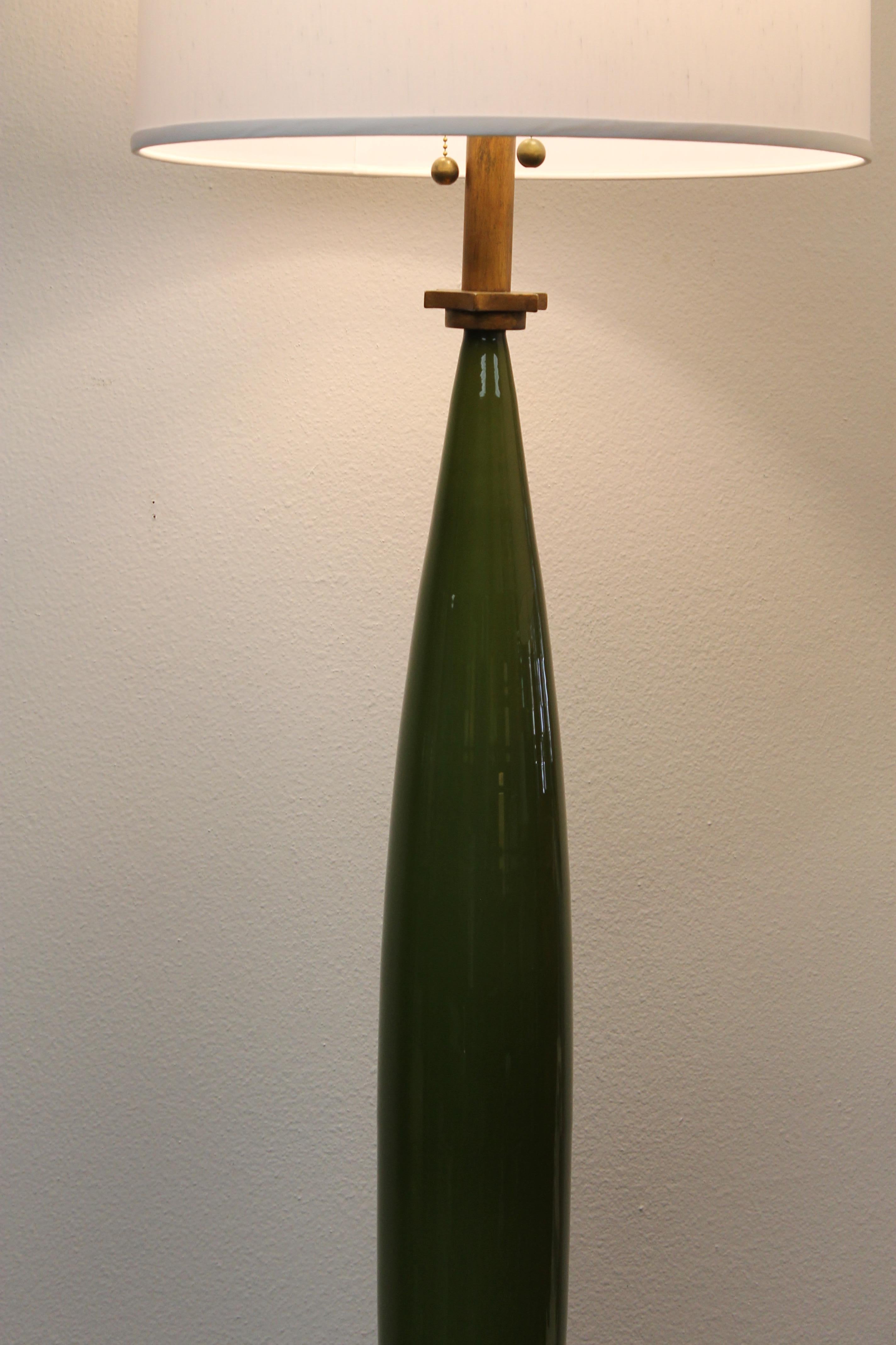 Rocket style green glass lamp on wood base, possibly Italian. Looks like it came out of a 1960s movie set. Measures: Green glass portion is 36.5