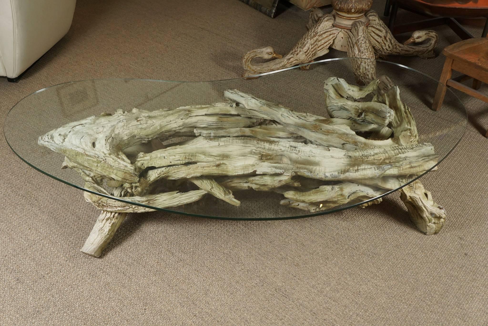 Here is a monumental root table base with a large kidney shaped glass top.
The root base has been whitewashed and has a pale gold wash as well.