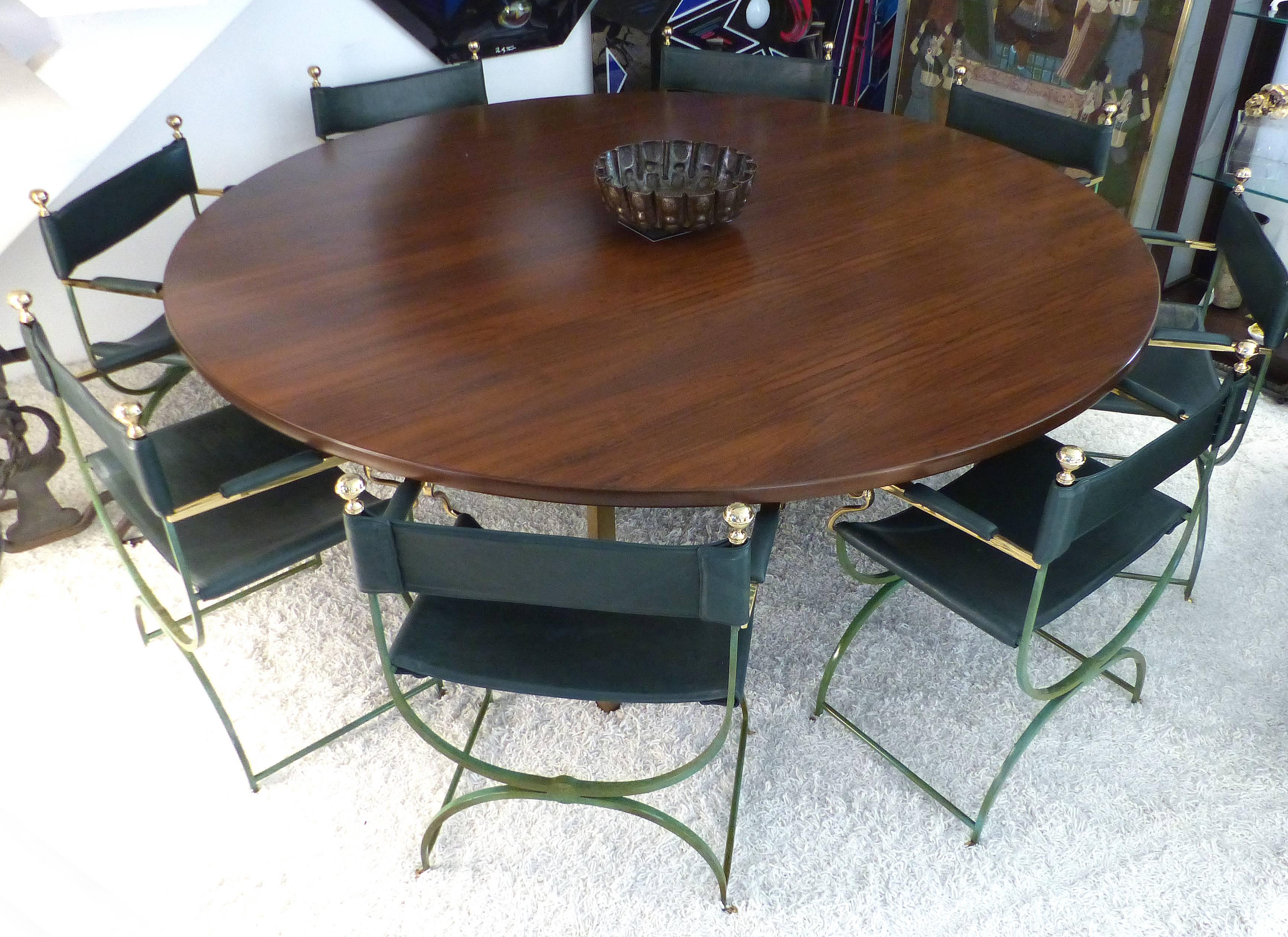 Dunbar Monumental Round Mid-century Rosewood Dining Table 

Offered for sale is a Dunbar matched grain Rosewood round monumental dining table with brass legs. Two matched grain panels are joined in the center of the table and supported by square
