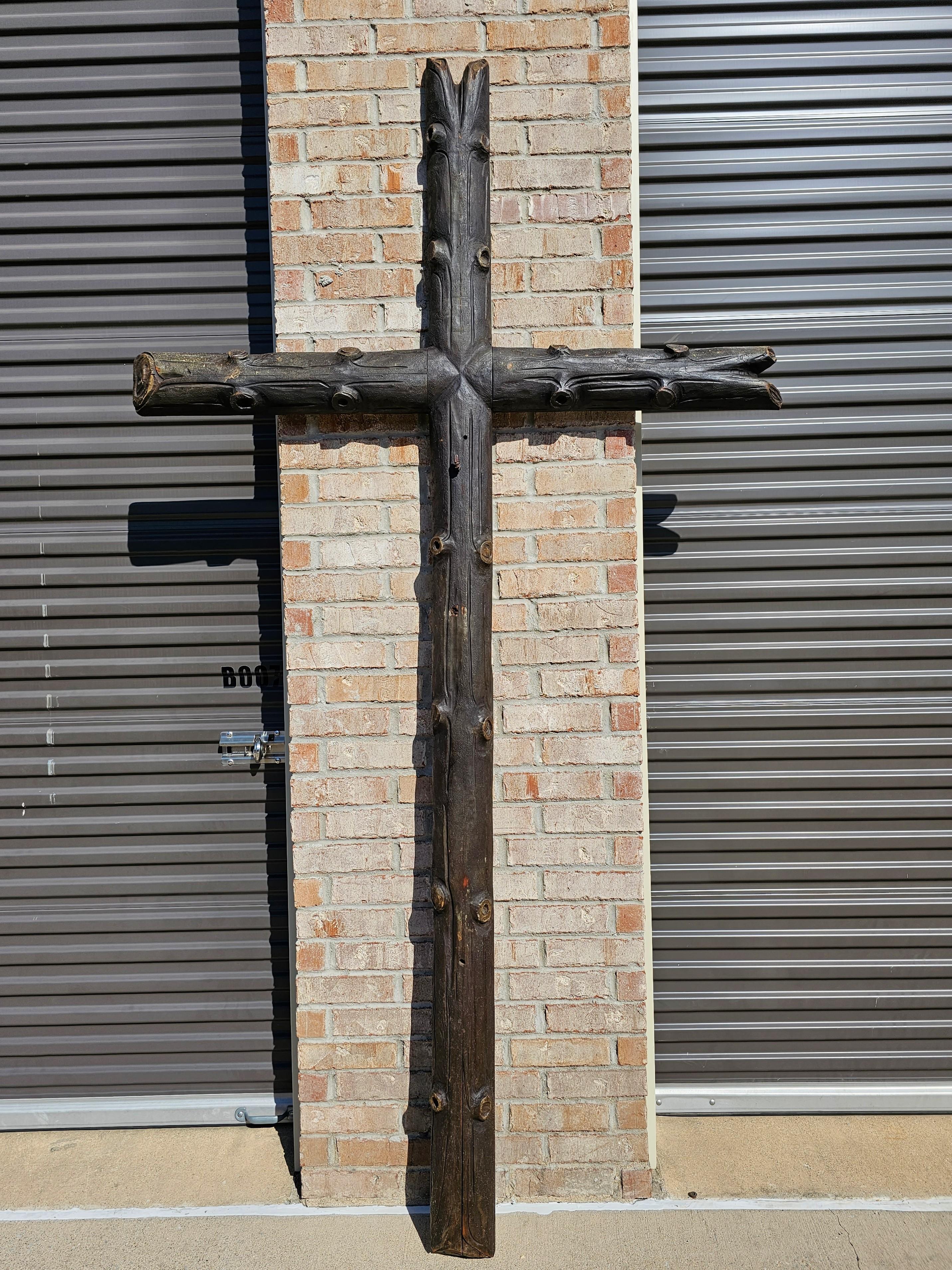 A massive nine foot tall by five foot wide rustic European antique ecclesiastical cross.

Hand-carved in the 19th century, originally commissioned for a church and mounted as a crucifix, featuring a large and distinctive naturalistic live edge