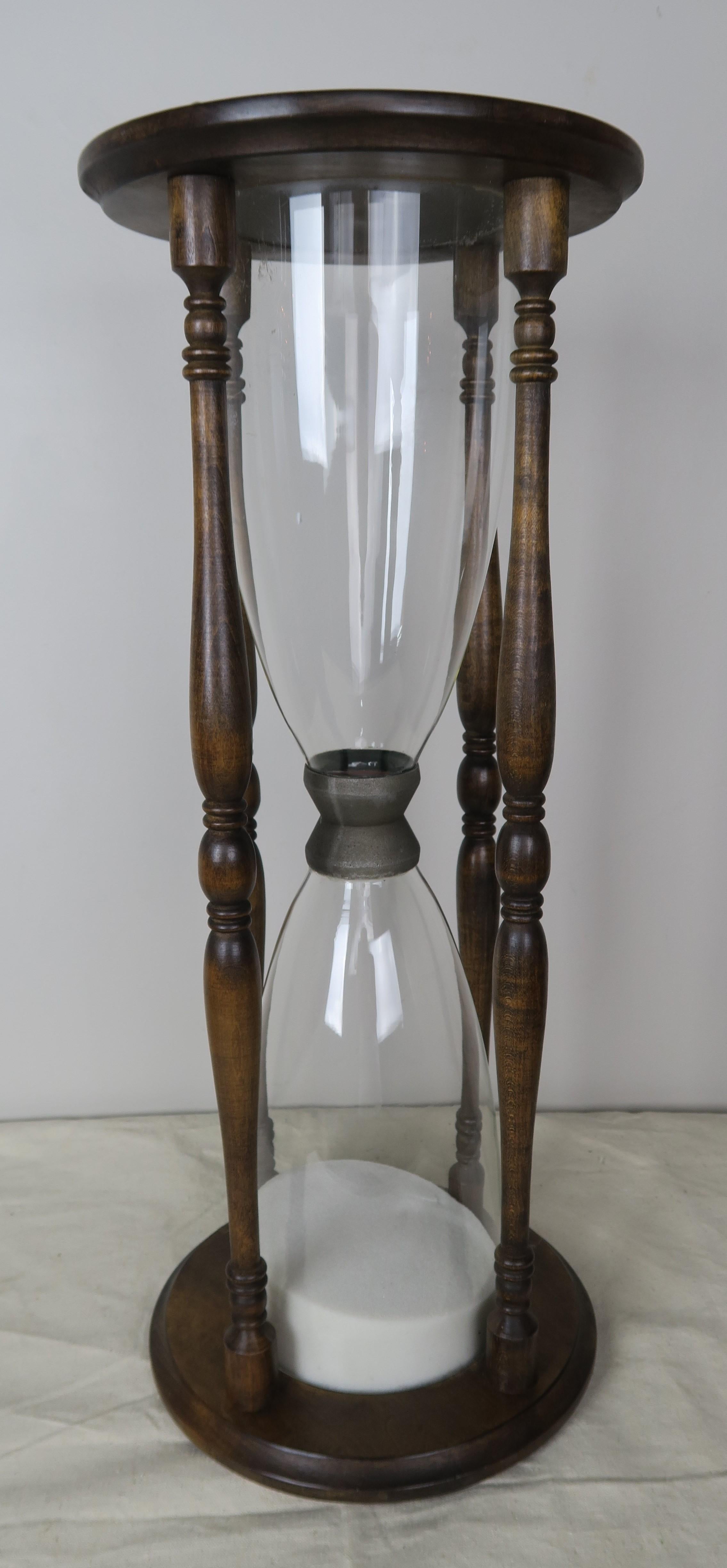 Monumental scale English walnut and glass hour glass.