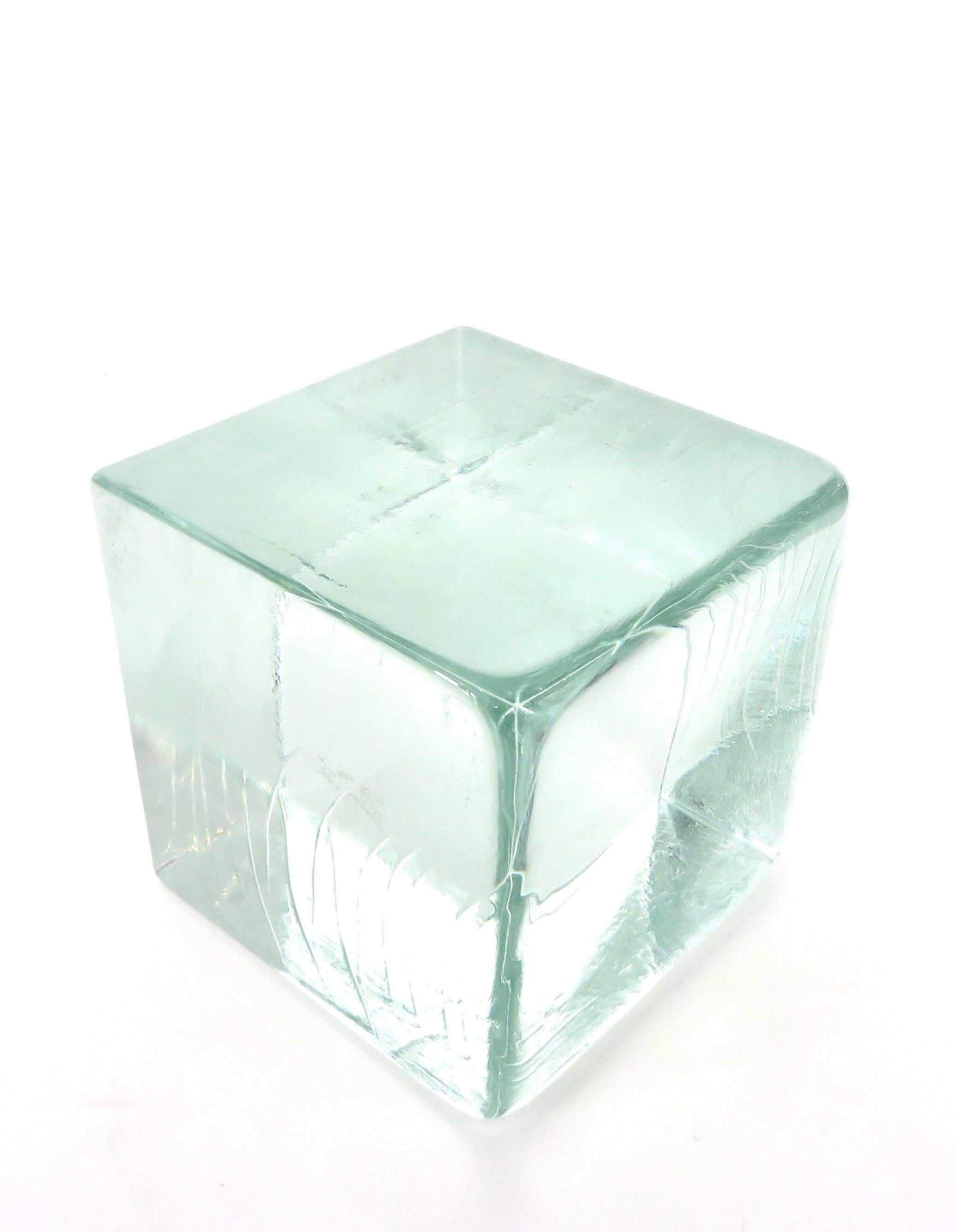 Monumental cast glass cube that can be used as a sculptural object or as a display cube with watery green coloration.