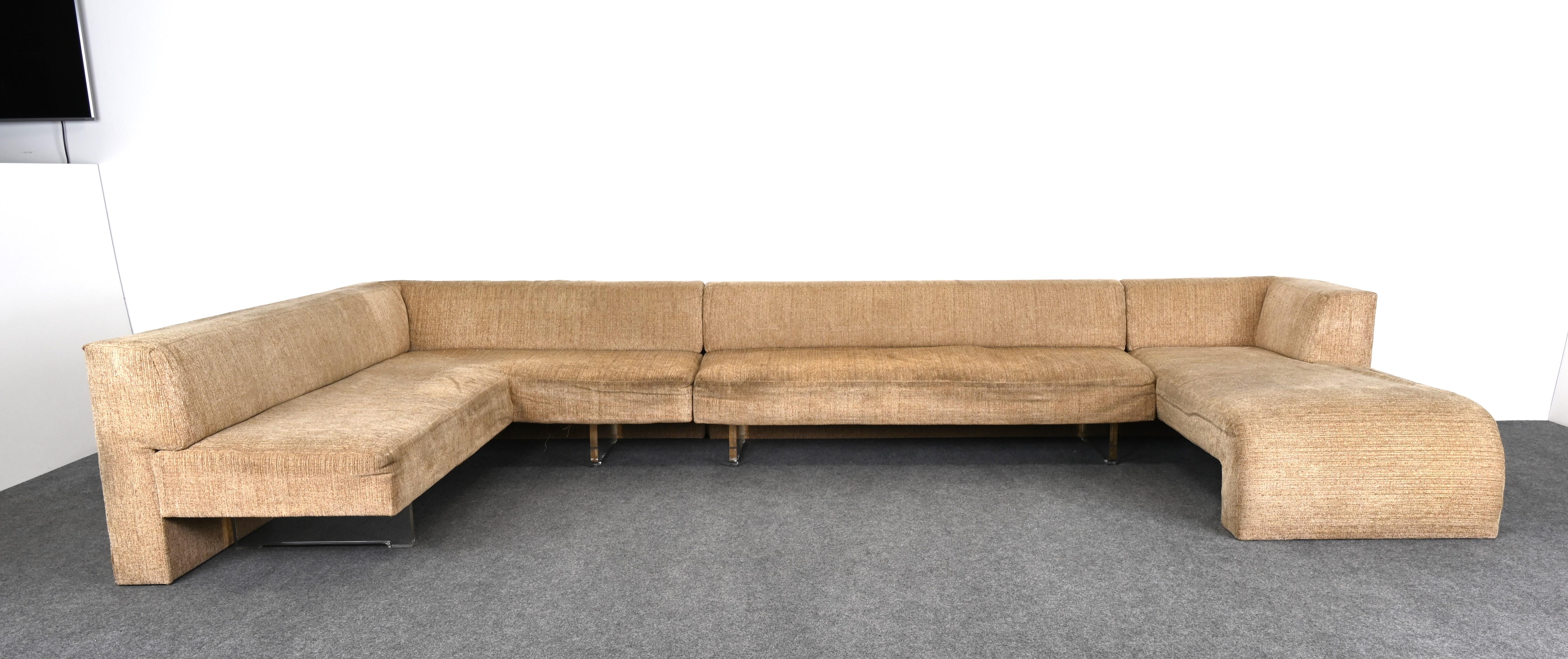 A monumental three-piece sectional Omnibus sofa by Vladimir Kagan, 1970s. This very large sofa would look great in any Mid-Century Modern or Contemporary home. The scale is wonderful, however, new upholstery is recommended. The lucite bases are in