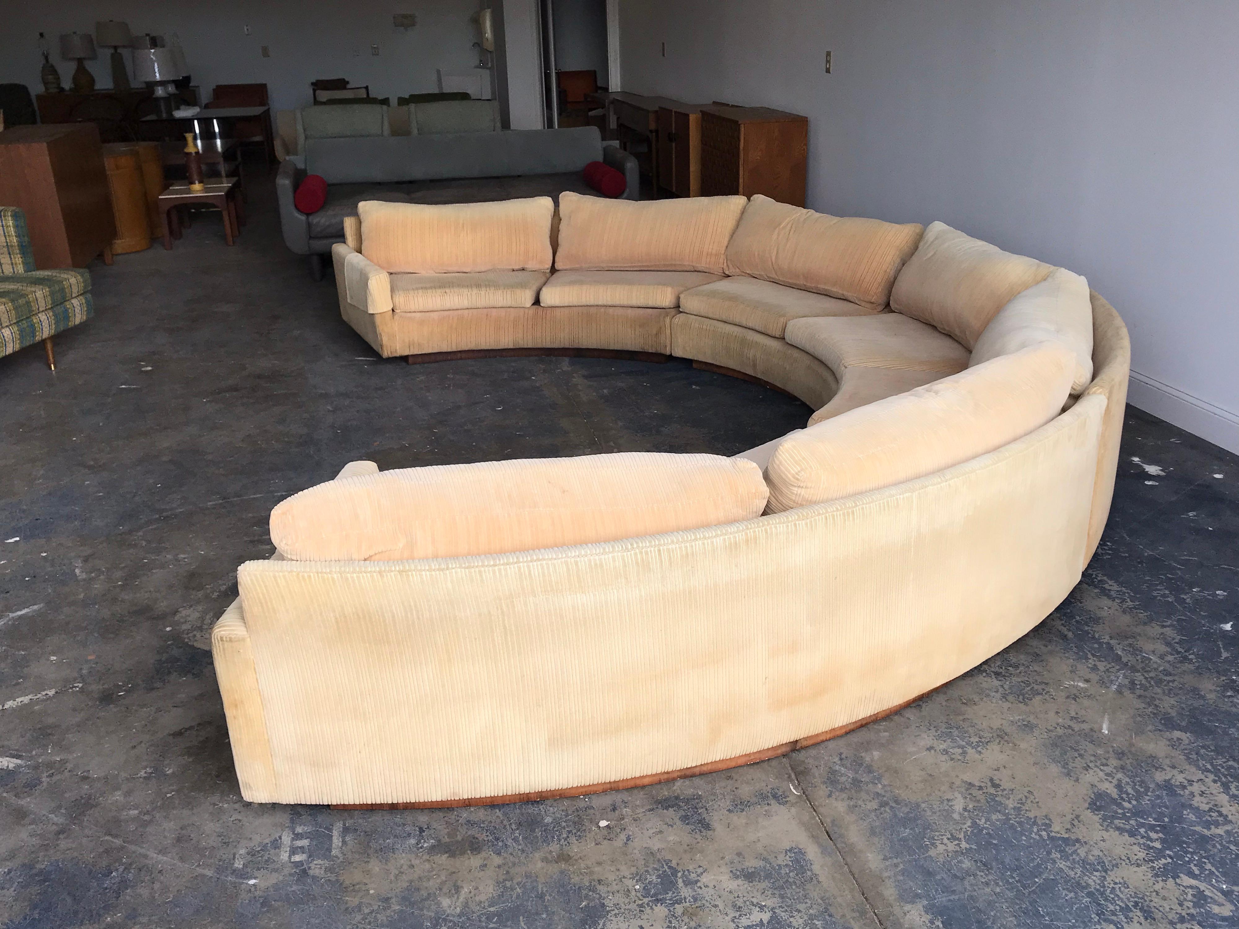 Monumental semi circular sofa by Milo Baughman. An iconic and desirable design by one of the best from the 20th century. While upholstery is free of rips or tears, there is fading and small stains. Reupholstery is recommended.


Opening from