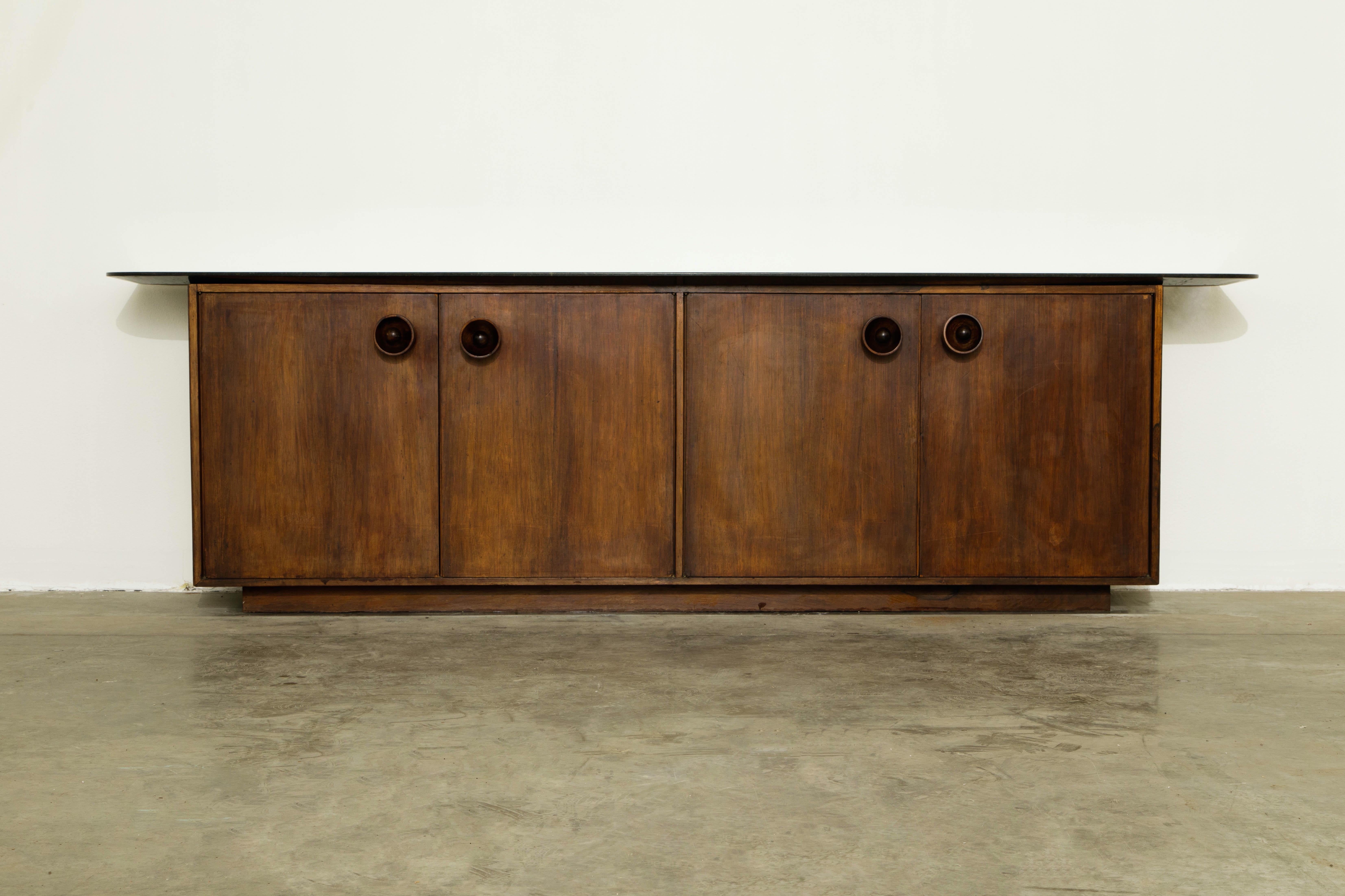 This monumental and important Jacaranda Rosewood sideboard / credenza by Sergio Rodrigues was created with the architect Bernardo Figuiredo for a custom installation in a mid-century modern Rio de Janeiro home in Brazil in which we acquired it from.