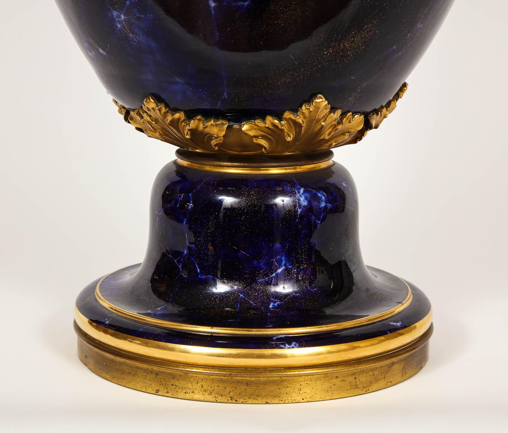A monumental palace size Sèvres Porcelain blue lapis painted vase. Beautifully hand-painted to imitate natural Lapis Lazuli stone. Hand-painted in Royal Cobalt blue color with white veins and 24-karat speckled gold highlight. Mounted in doré bronze.