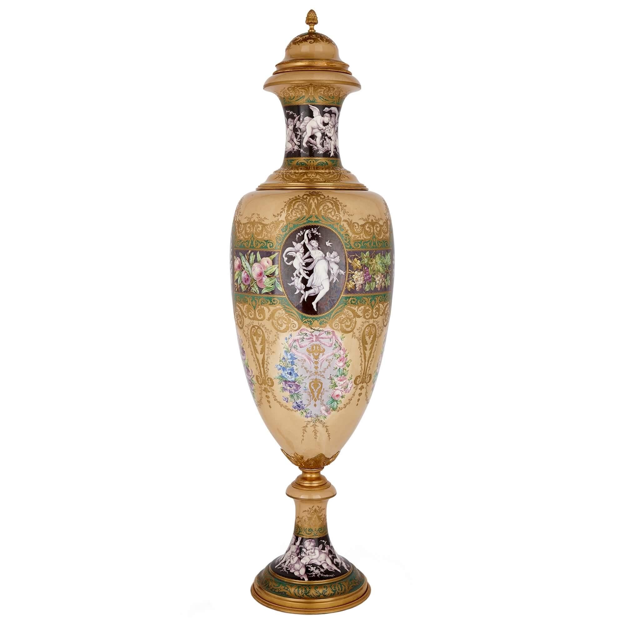 Monumental Sèvres style ormolu mounted porcelain vase of the Four Seasons
French, c.1895
Height 152cm, diameter 45cm

Set on a polychrome ground, dominated by a rare and fitting beige ground, which is accentuated and banded with strips in green,