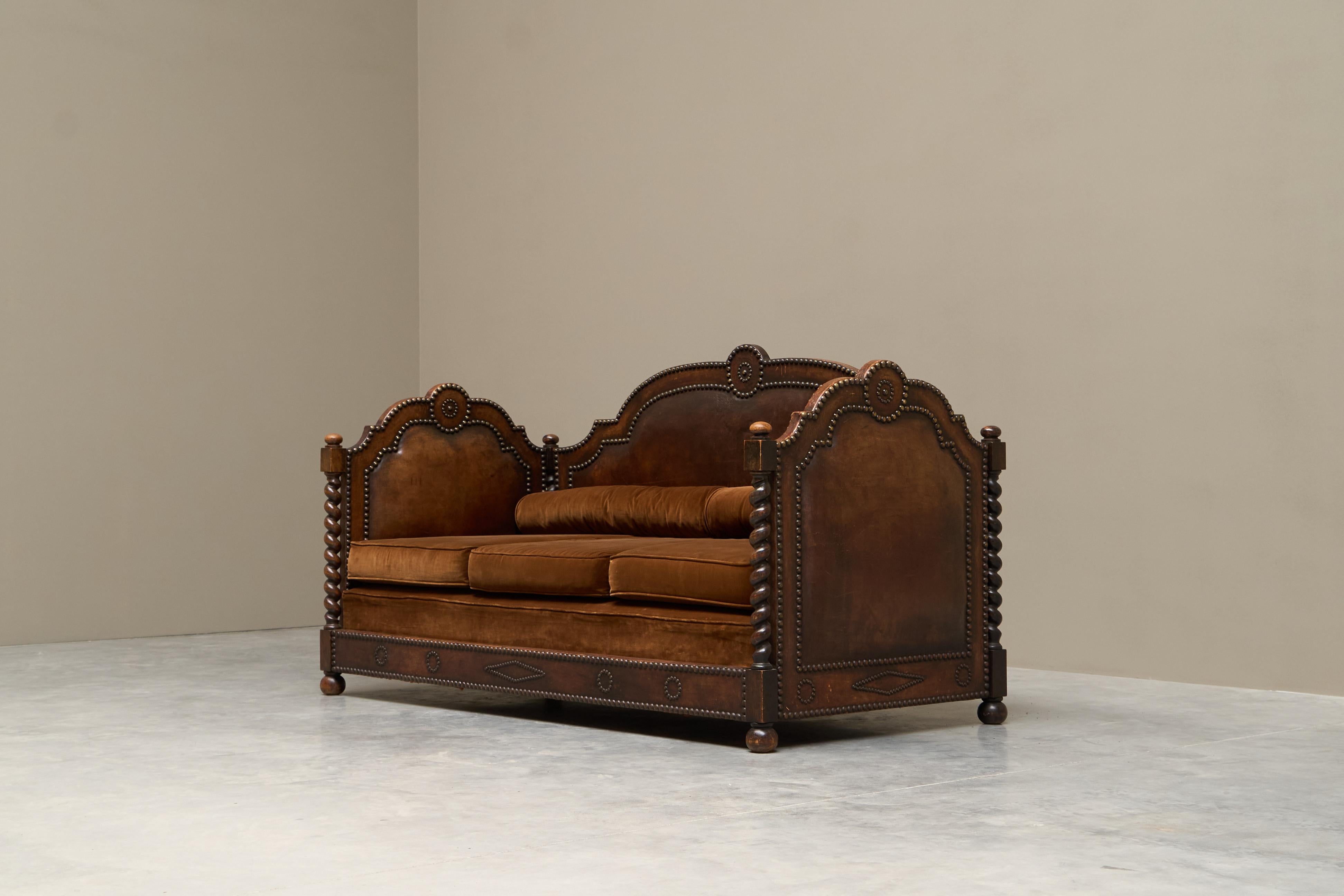 Monumental Sofa in Patinated Dark Brown Leather, Brass Studs and Velvet Late 19th Century

A very remarkable and monumental late 19th century sofa in patinated dark brown leather, studs and velvet upholstery. 

This is a statement piece for sure,