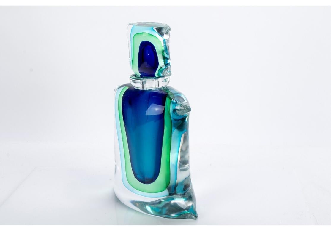 A monumental Murano art glass perfume bottle designed by Luigi Onesto with triple Sommerso technique in blues and greens.
Dimensions: 11