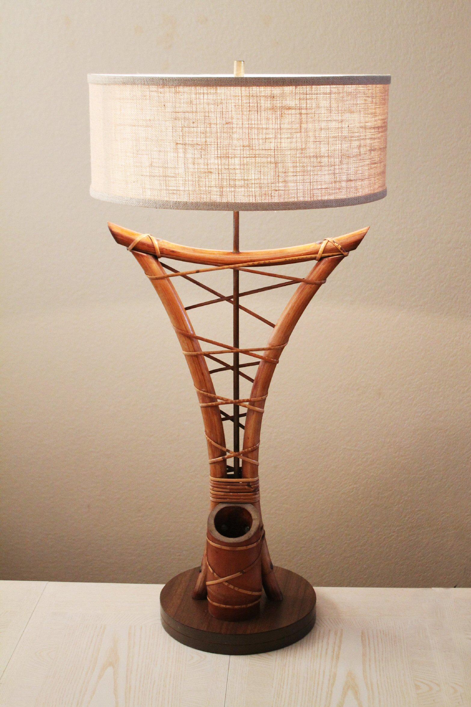 MONUMENTAL


BAMBOO & WALNUT
POLYNESIAN STYLE
TABLE LAMP

In the Manner of McGuire & Gabriella Crespi

Circa 1950

At the very beginning of the Post-War Polynesian or South Pacific craze which took over America during the forties and fifties, there