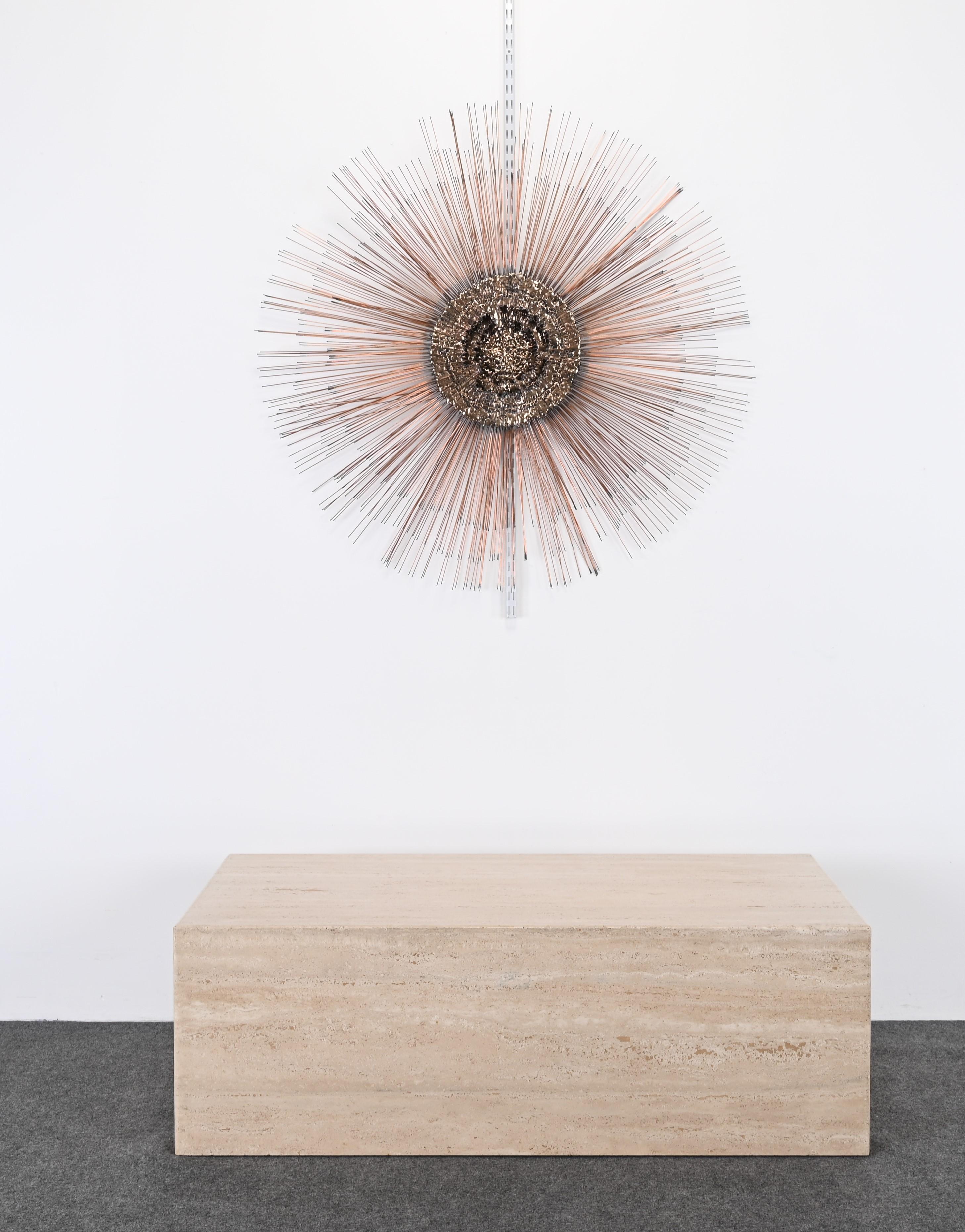 A monumental Brutalist starburst metal wall sculpture made out of steel, brass, bronze, and copper. This modern sculpture originated out of a Pennsylvania estate that was decorated in Mid-Century Modern from the 1980s. The sculpture was purchased