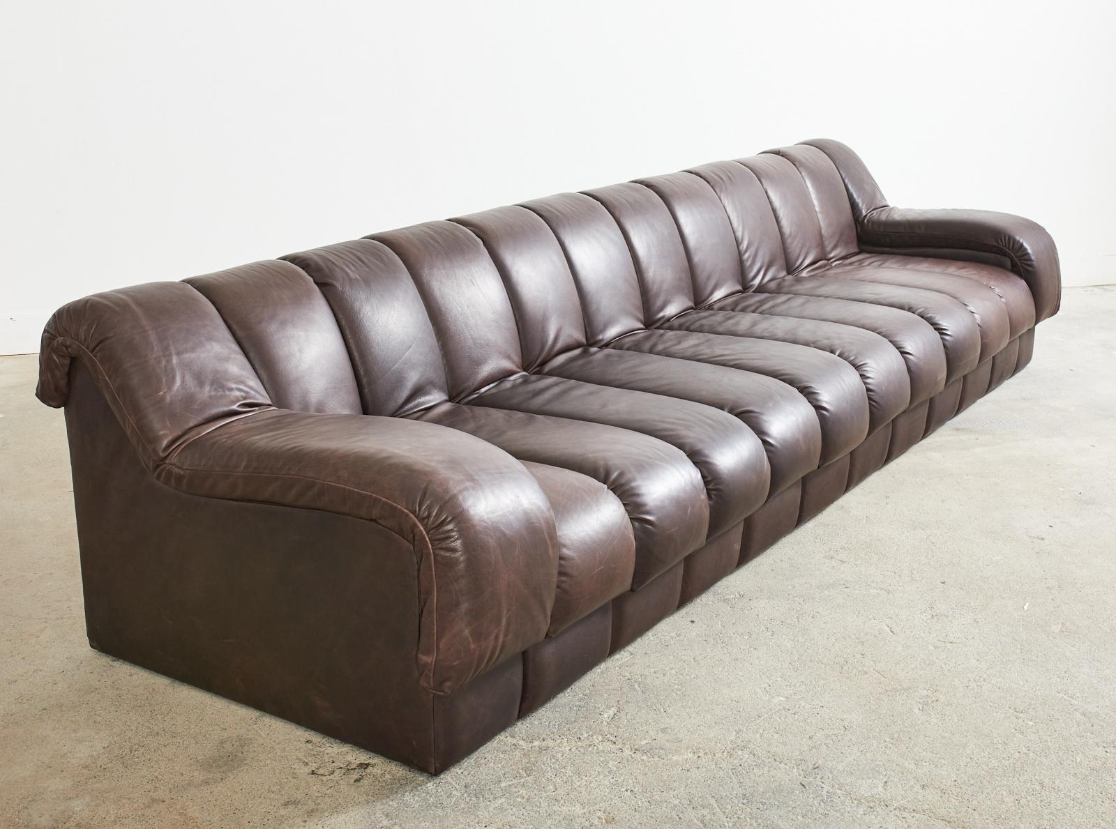 Bespoke monumental channeled leather sofa made in the manner and style of Steve Chase for Martin/Brattrud. Grand sofa known as the Monterey features a long hardwood frame covered with thick espresso leather in 12 wide channels, elements, or