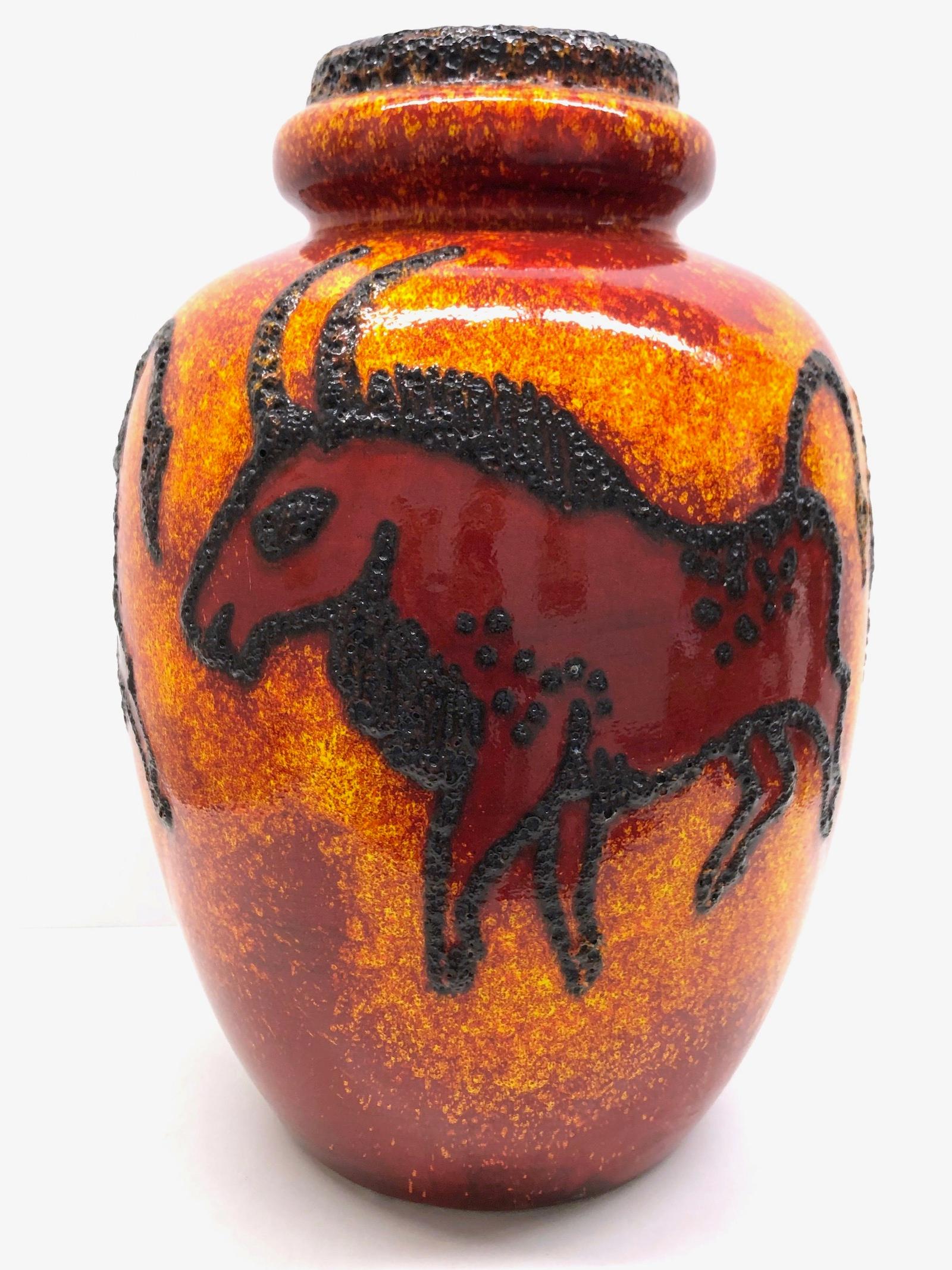 An amazing lava glazed ceramic Mid-Century Modern floor vase made in Germany, circa 1970s. This is a heavy floor vase. Yellow, red, orange and brown colored, with lava stripes. Vase is in very good condition with no chips, cracks, or flea bites. It