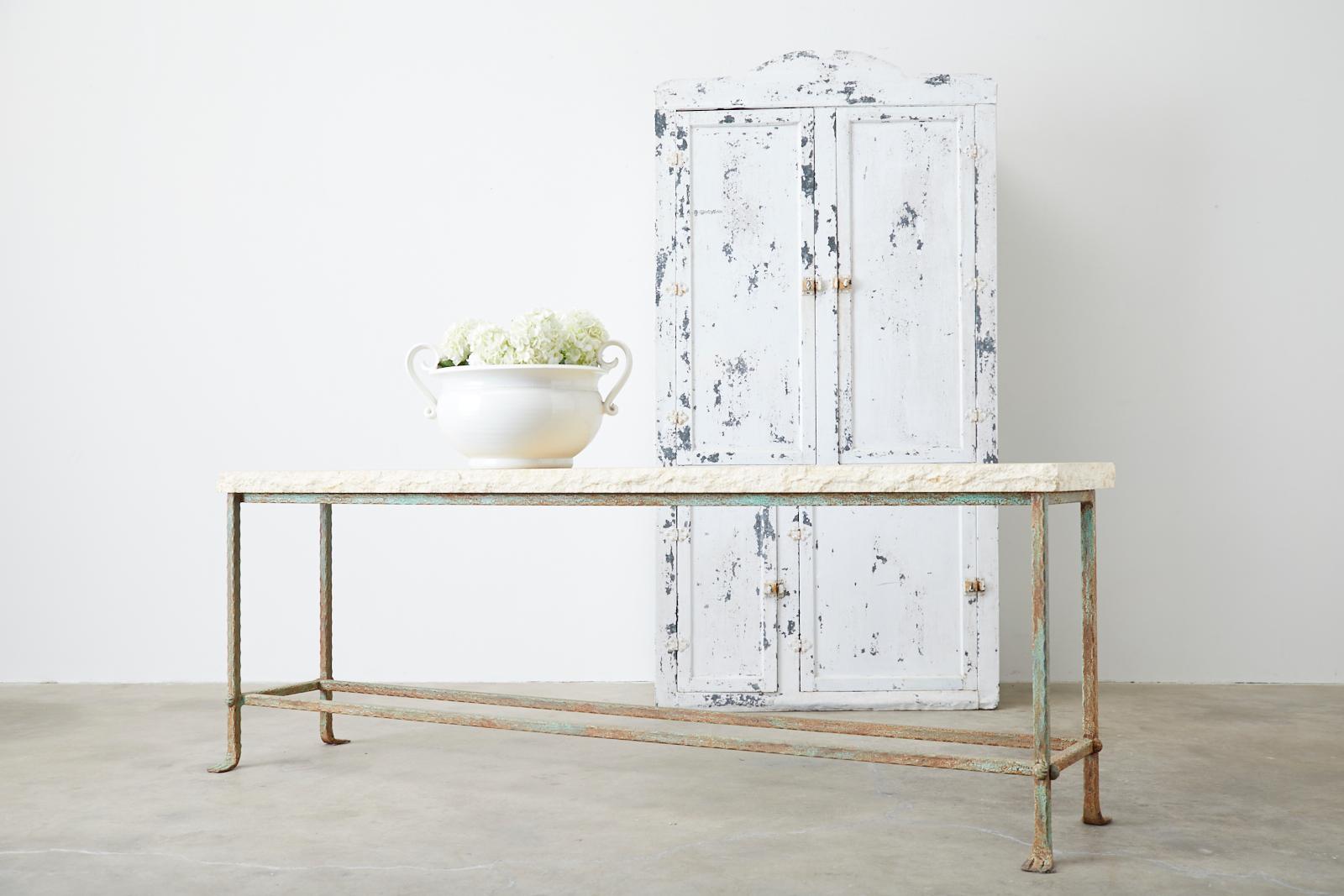 Amazing monumental garden table or console table constructed from molded stone and iron. The stone top is 2 inches thick and features a hand-chiseled live edge with a rough travertine style finish. The large iron base has a unique hand-hammered