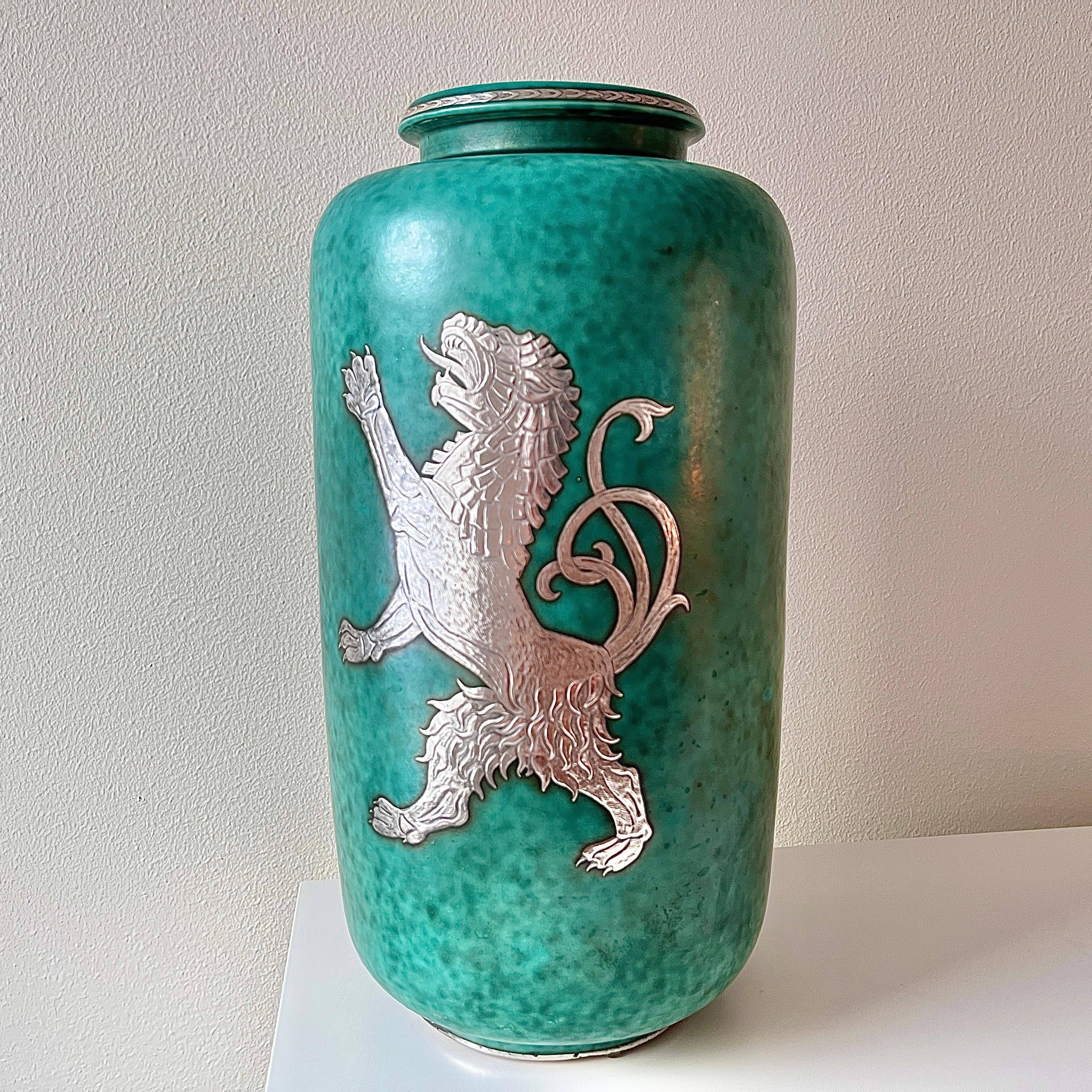 Monumental stoneware vase designed by Wilhelm Kåge from the ‘Argenta’ series for Gustavsberg, Sweden, 1930s. Signature green glaze with decor of a mythical lion, (typical for the Swedish grace period) and stripes at the rim and base in
