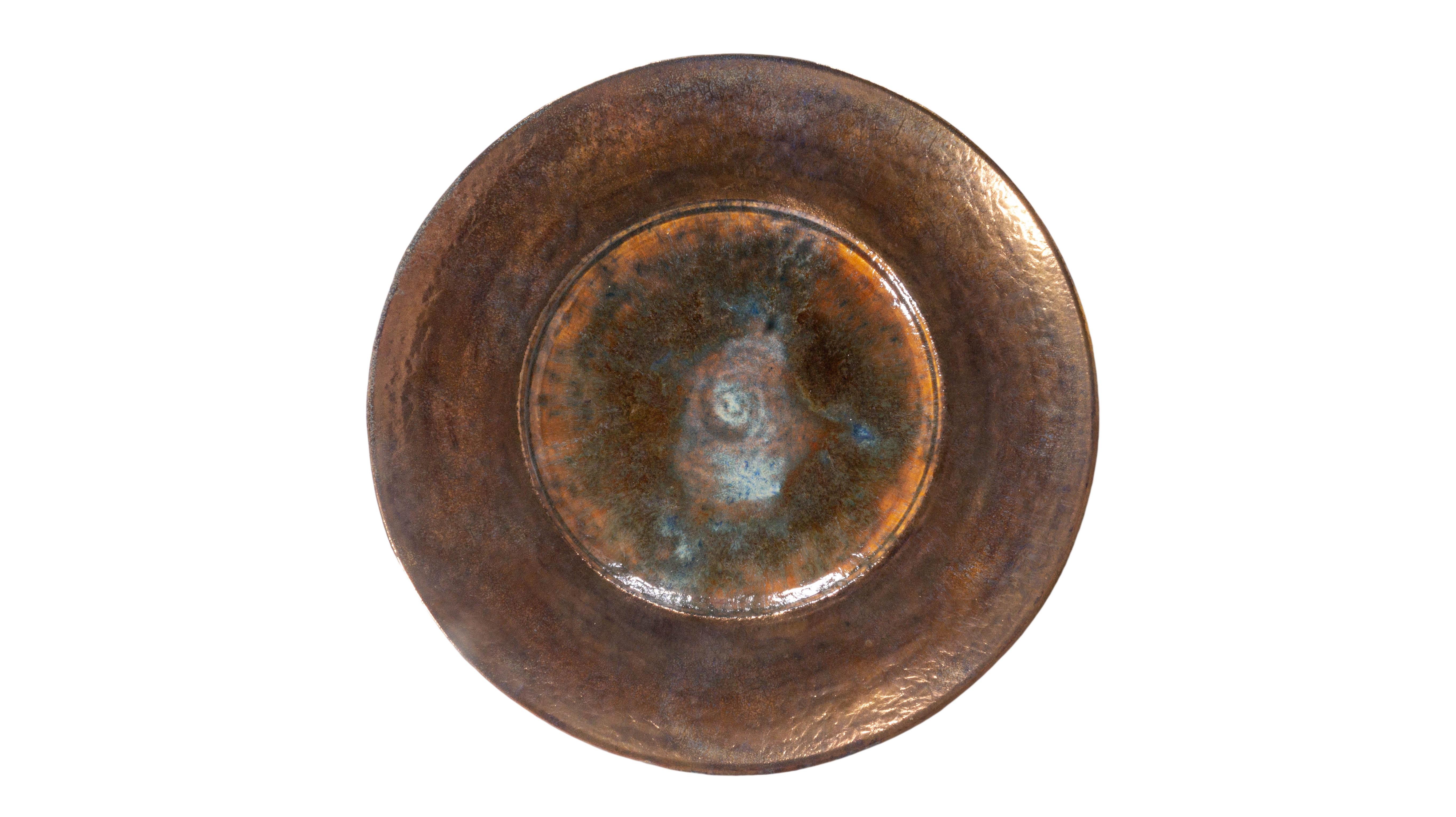 This monumental studio art pottery charger is artfully lustre- galzed and features beautiful oxidized blues. The hand thrown ceramic piece is one of a kind and makes a beautiful piece to display alone or with a collection. 

This piece is a part