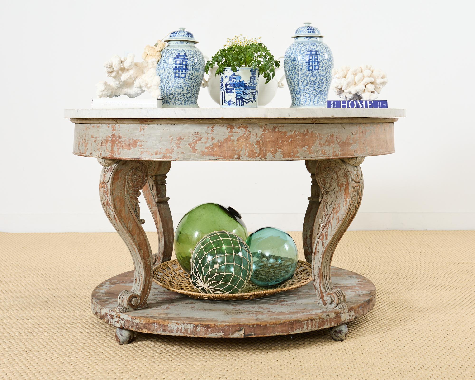 Impressive grand round marble top center table made on a monumental scale in the neoclassical Gustavian taste. The Swedish table features a massive 1.5 inch thick slab of Carrara marble resting on a carved wood base. The round frieze is supported by