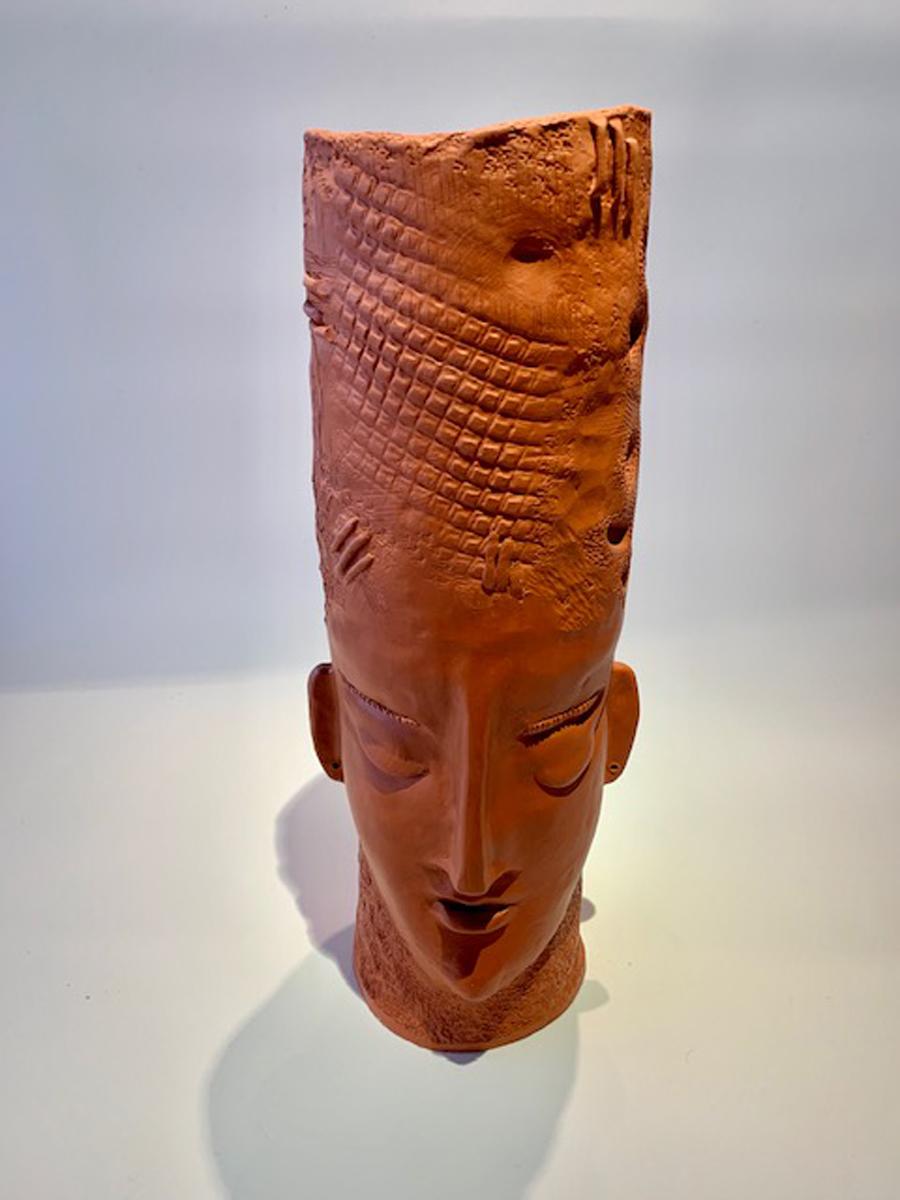 Monumental modern/contemporary ceramic sculpture artisan vase - the vase is comprised out of terracotta colored ceramic and features two detailed chiseled men's faces. Attention to detail and technique is shown throughout the vase face's.