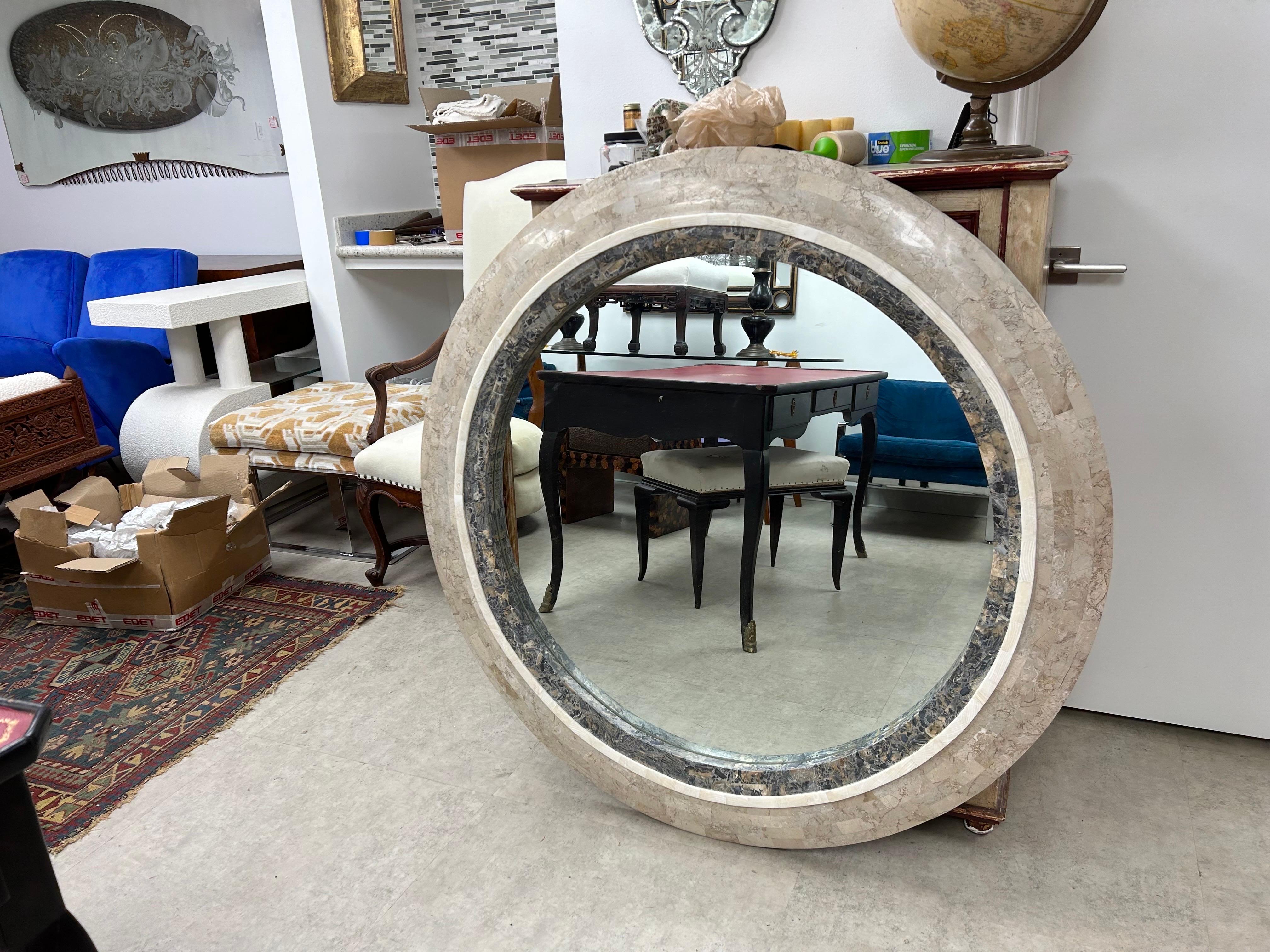 Monumental Tessellated Stone Mirror.
This stunning Hollywood Regency round tessellated stone mirror was expertly created with a cream colored marble or travertine surrounding an interior of a darker neutral marble.
A true statement mirror!