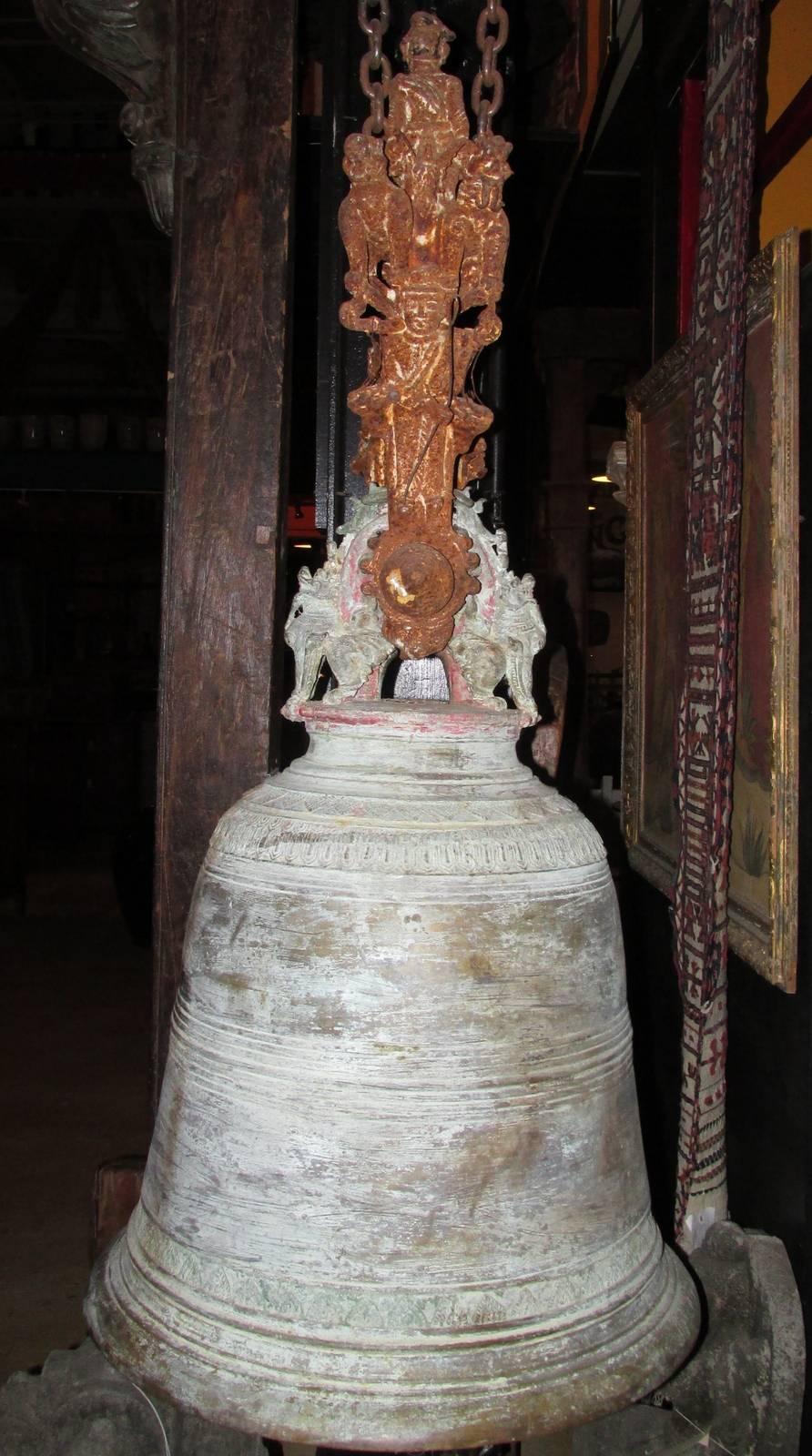 A huge antique bronze bell with iron top. This large bell has all the original patination from many years of use and exposure. The iron also has all its original oxidation. This bell used an exterior clapper that hit the bell from the outside and