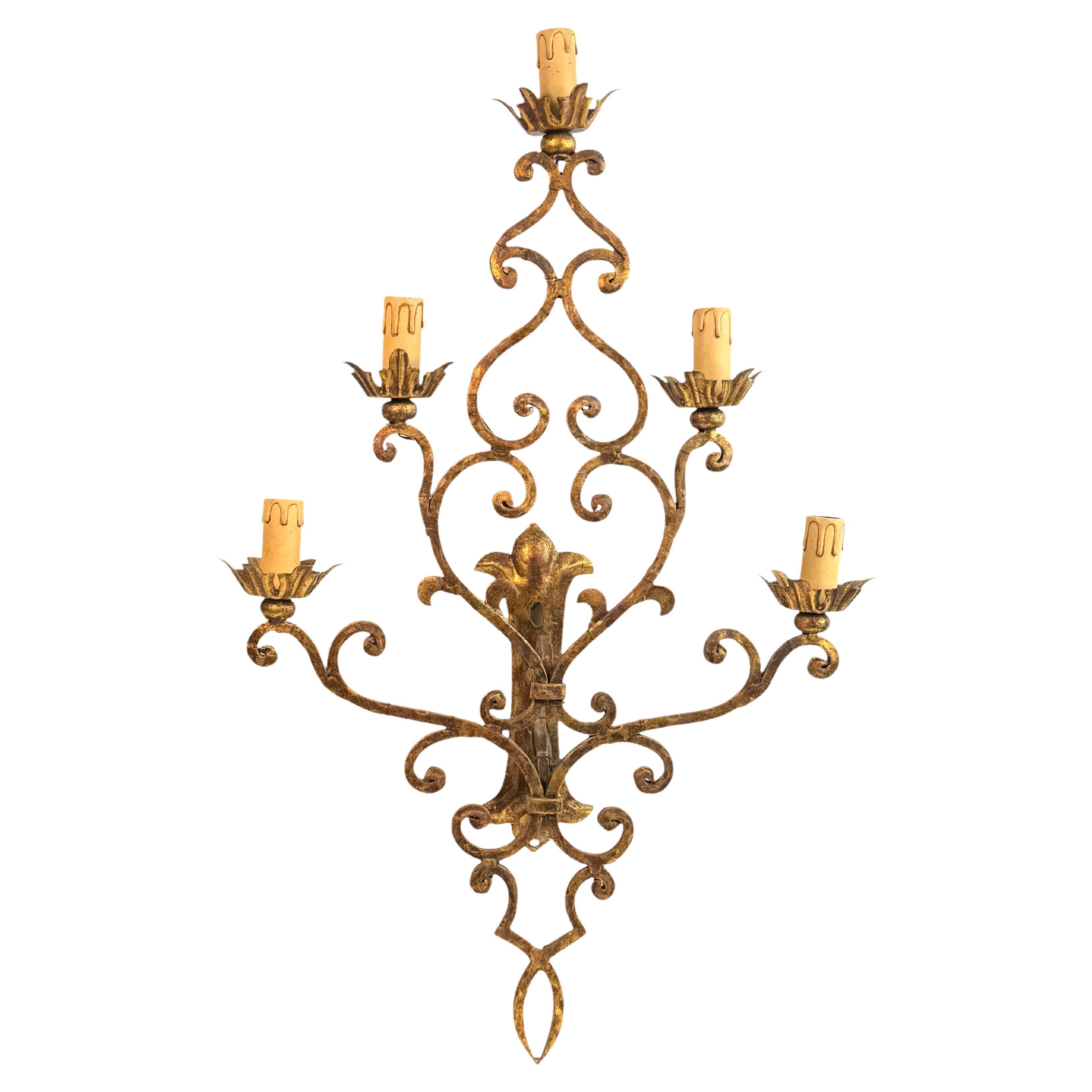 Un'unica applique a 5 luci in metallo dorato e toleware. L'apparecchio richiede cinque lampadine europee E14 a candelabro, ciascuna con una potenza massima di 40 watt. L'applique ha un colore bellissimo e conferisce a ogni stanza una dichiarazione