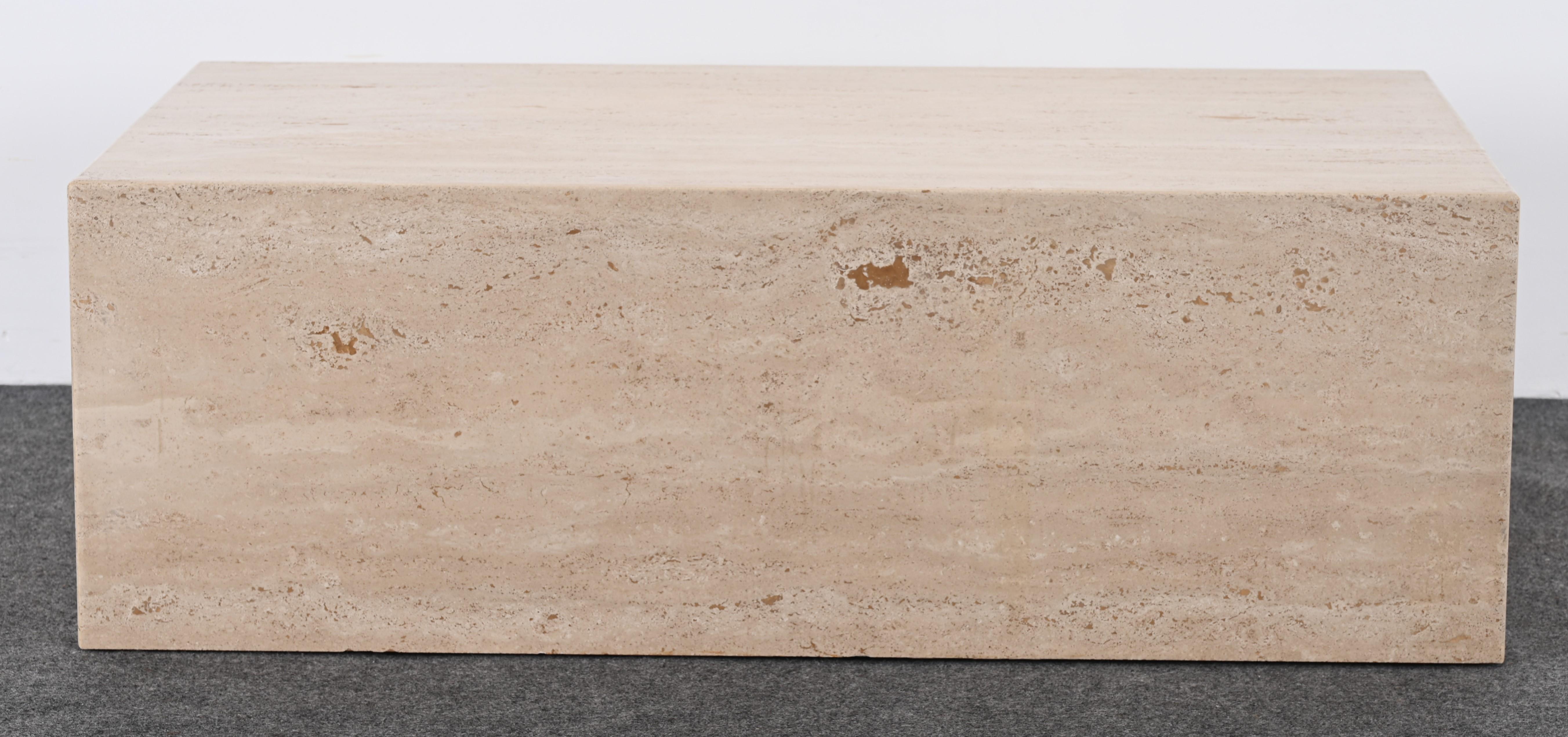A monumental travertine marble coffee table in the style of Roche Bobois. This coffee table would look great in a contemporary setting with a focus on minimalism. Monolithic in size and scale. The natural tones and marbelized graining have an