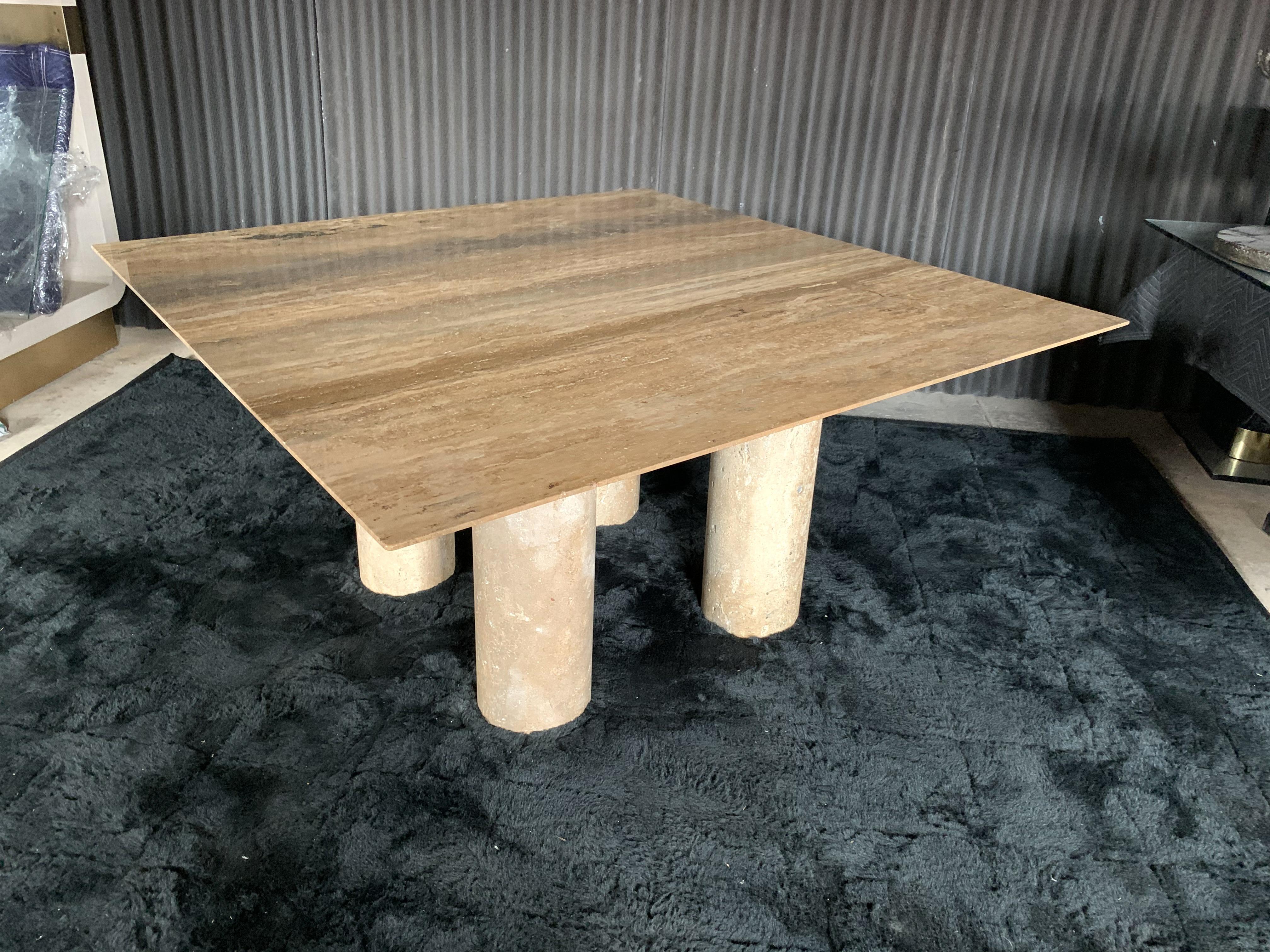 Gorgeous and monumental polished travertine top dining table with 4 massive unpolished unfilled stone column bases, in the style of Mario Bellini.
This table was built to impress and is in stunning condition.
No chips or breaks anywhere. Polished