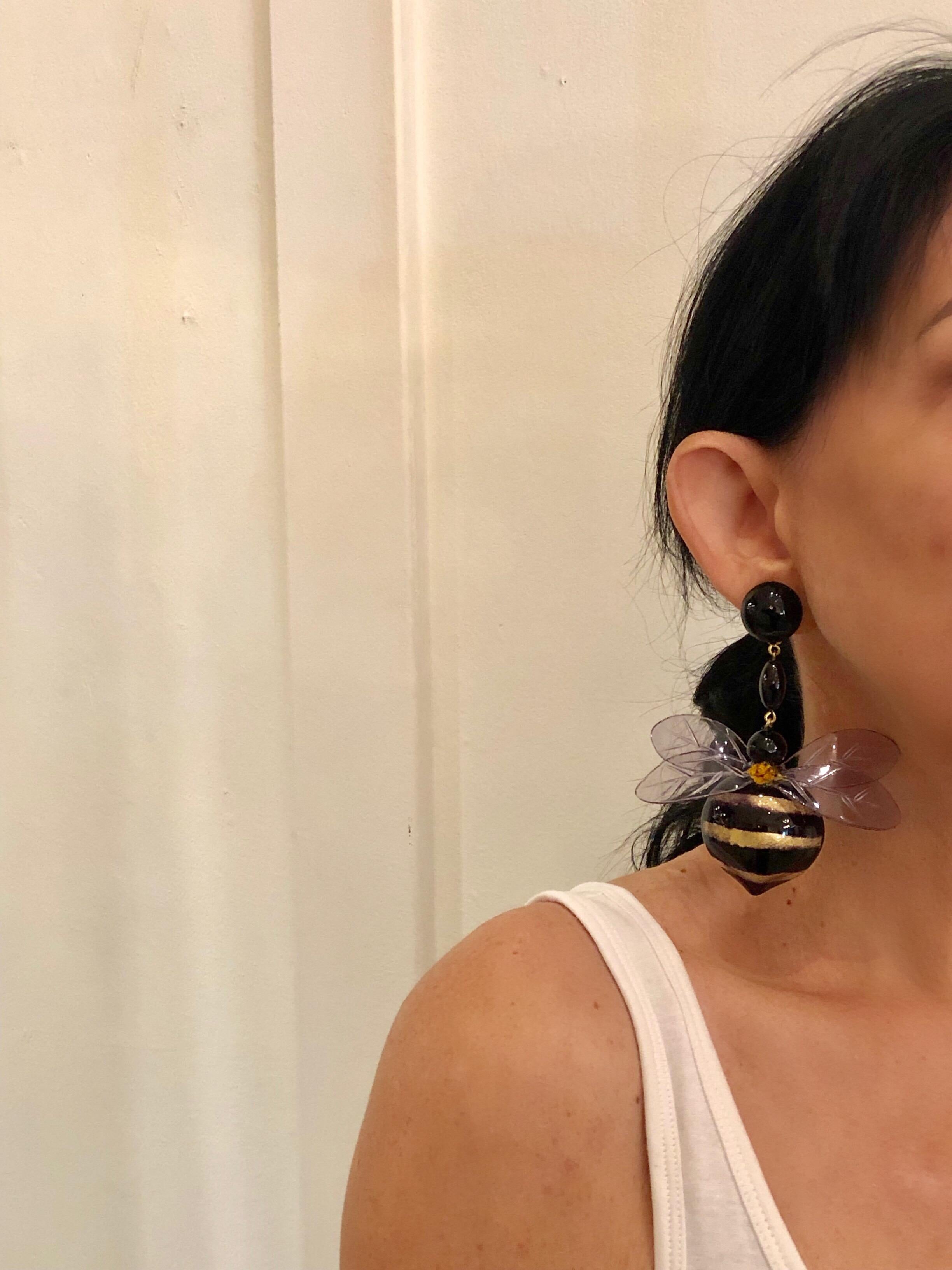 Unique handcrafted contemporary artisanal clip-on Statement earrings made in Paris France by Cilea Paris - lightweight, featuring two large black and gold bumblebees. The bumblebees are comprised out of resin and enamel and have carved clear lucite