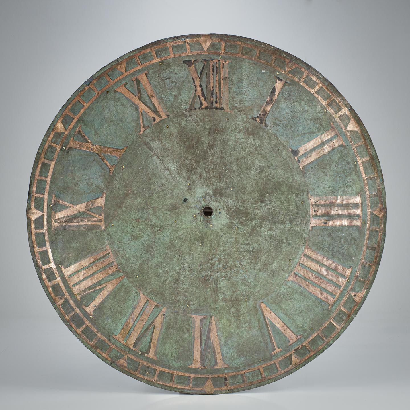Extraordinary, Monumental scale copper clock face. Natural verdigris patination. England. Early 20th Century. Fixed to later board backing for stability and hanging. Provenance St James Chapel, Okehampton, Devon, UK.