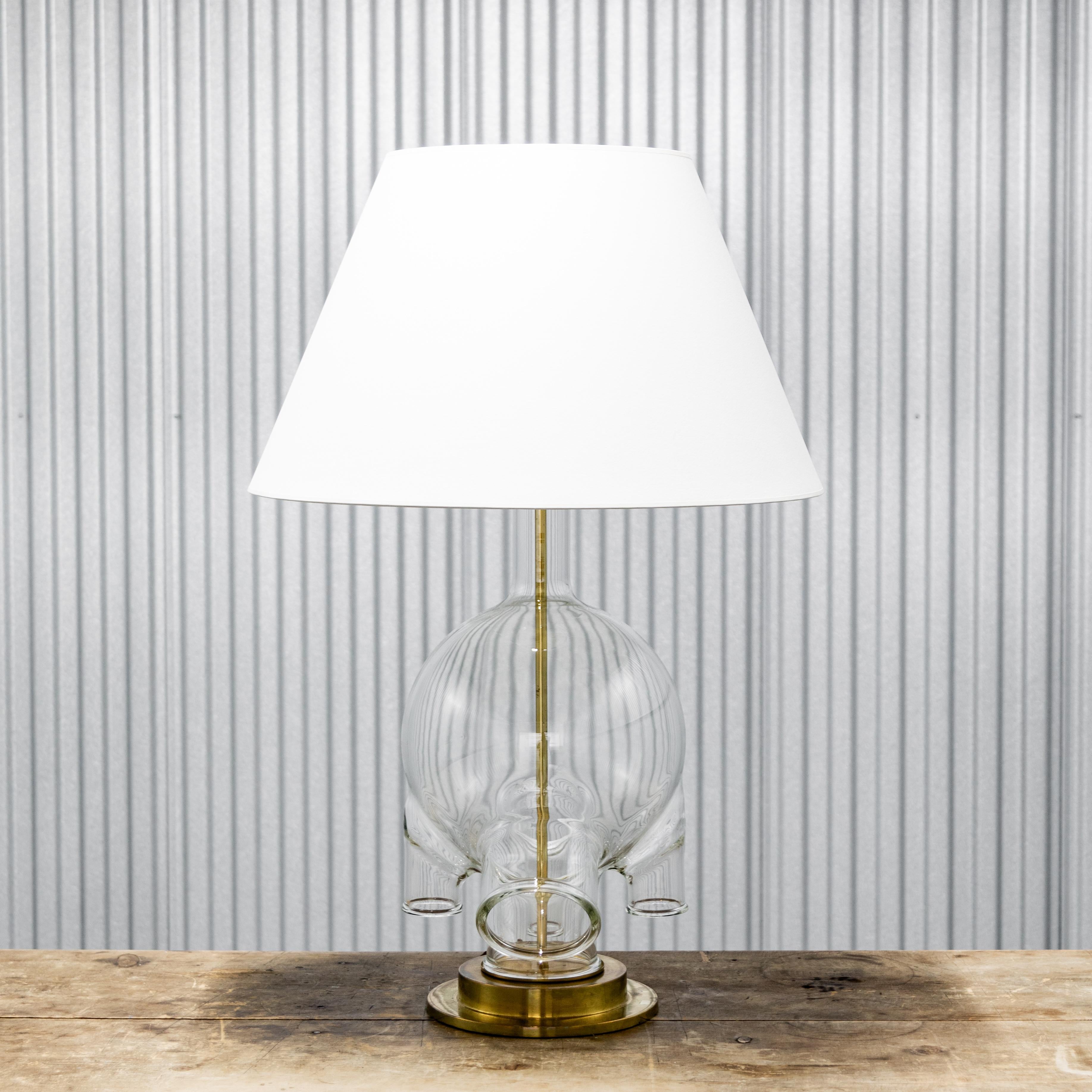Large monumental vintage lab glass table lamp with brass base and new paper shade, circa 1950s.