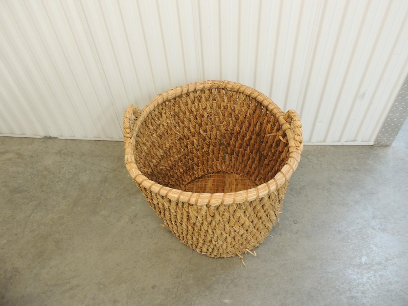 Large scale vintage water hyacinth logs basket with handles
Woven wicker bottom
Natural fiber is wrapped around a metal structure to shape the basket
Handcrafted in South America, 1990's
Ideal as a planter in the garden
Size: 26
