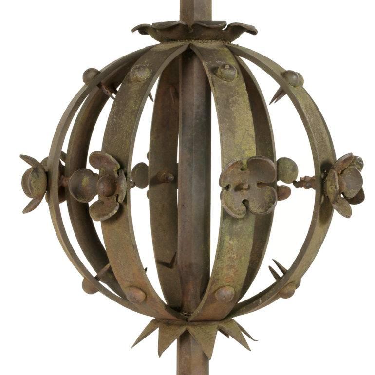 A monumental, 19th century wrought iron weather vane with elaborate scrolled details throughout, the top ‘vane’ with pierced stars and sun motifs and a fleur-de-lys border, the central ‘globe’ with florets and iron stud detailing.

The vane itself