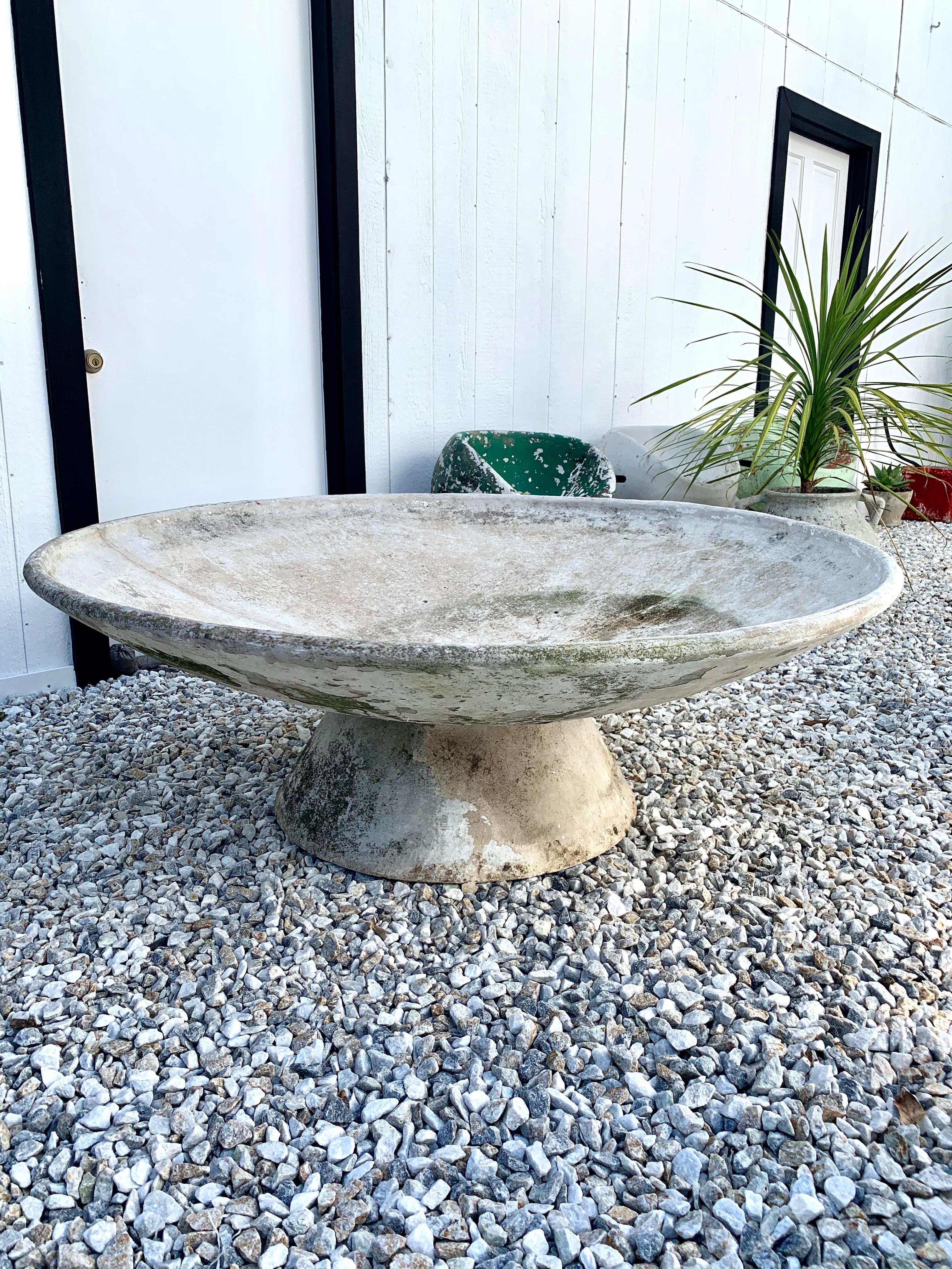 Fantastic cement planter by Swiss designer Willy Guhl for Eternit. Large concrete pedestal base with massive concrete bowl that sits on top. Bowl can sit flat or angled in a multitude of directions. Great original patina. Great for indoors or