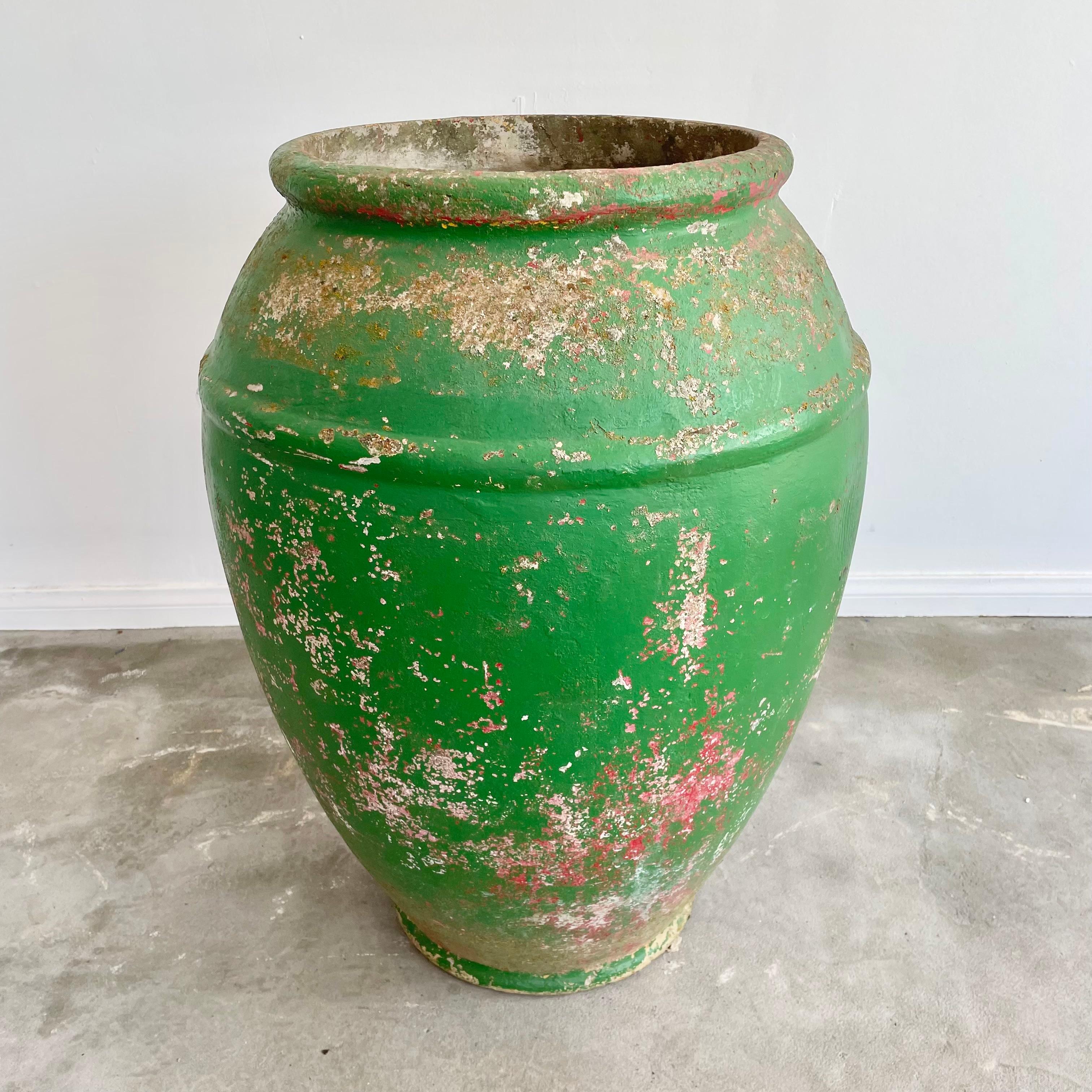 Unusual concrete urn by Willy Guhl. Rare model and size. Excellent green patina with undertones of red, pink and grey. Urn has a delicate cement ridge around the mouth as well as around the widest part of the jar giving it depth and great lines. The