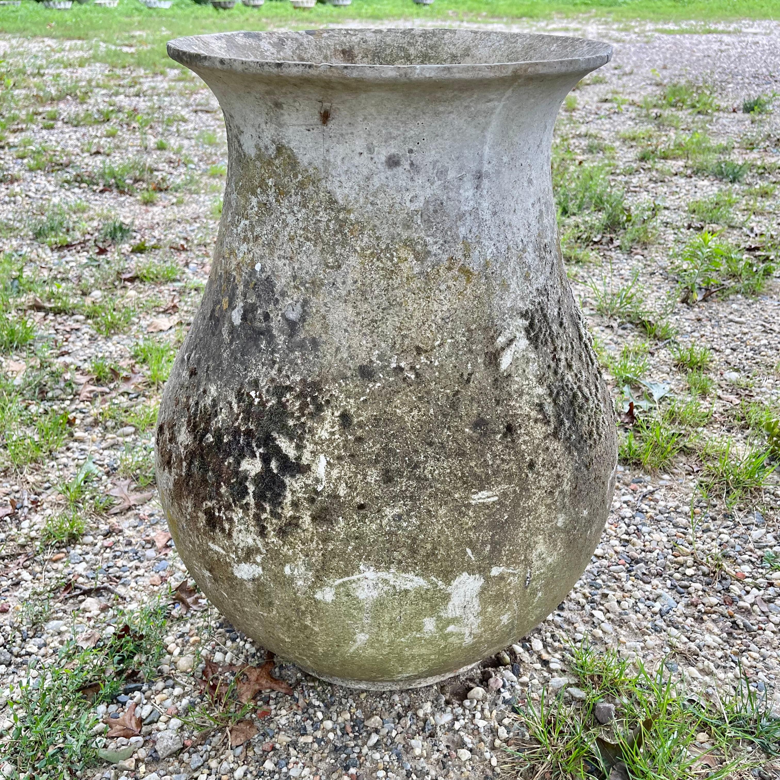 Spectacular concrete vase by Willy Guhl. Extremely rare model. Slightly tapered neck with pronounced lip spout. Made of fiber cement. Decades of patina, moss and paint. Colors vary from grey to green and yellow. Beautiful texture and color with