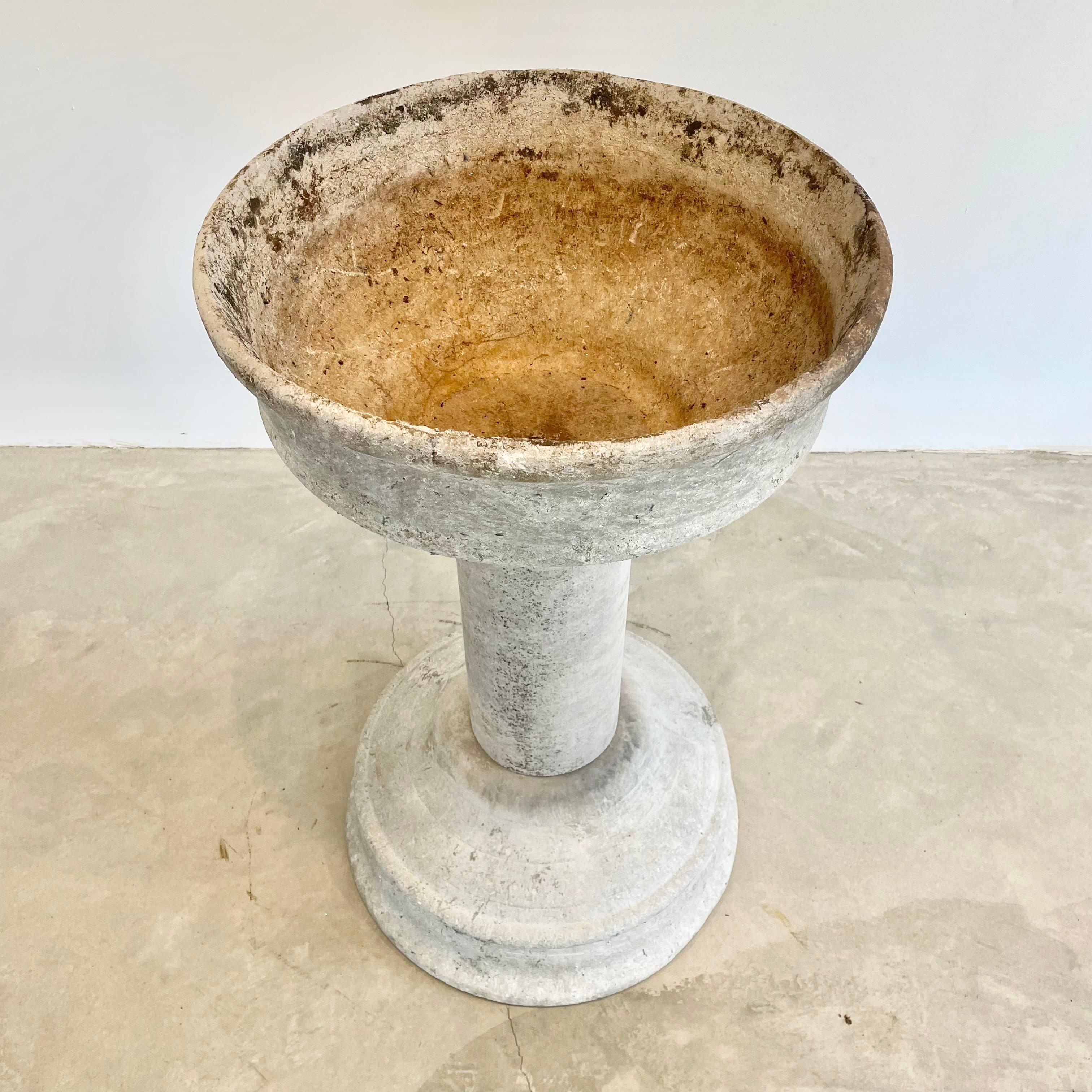 Massive and rare concrete fountain by Willy Guhl for Eternit. Fabricated out of three pieces of cement. Large basin on both ends with hollow cylinder connecting the two. Great sculpture and object. Bowl has factory drilled holes to allow water to