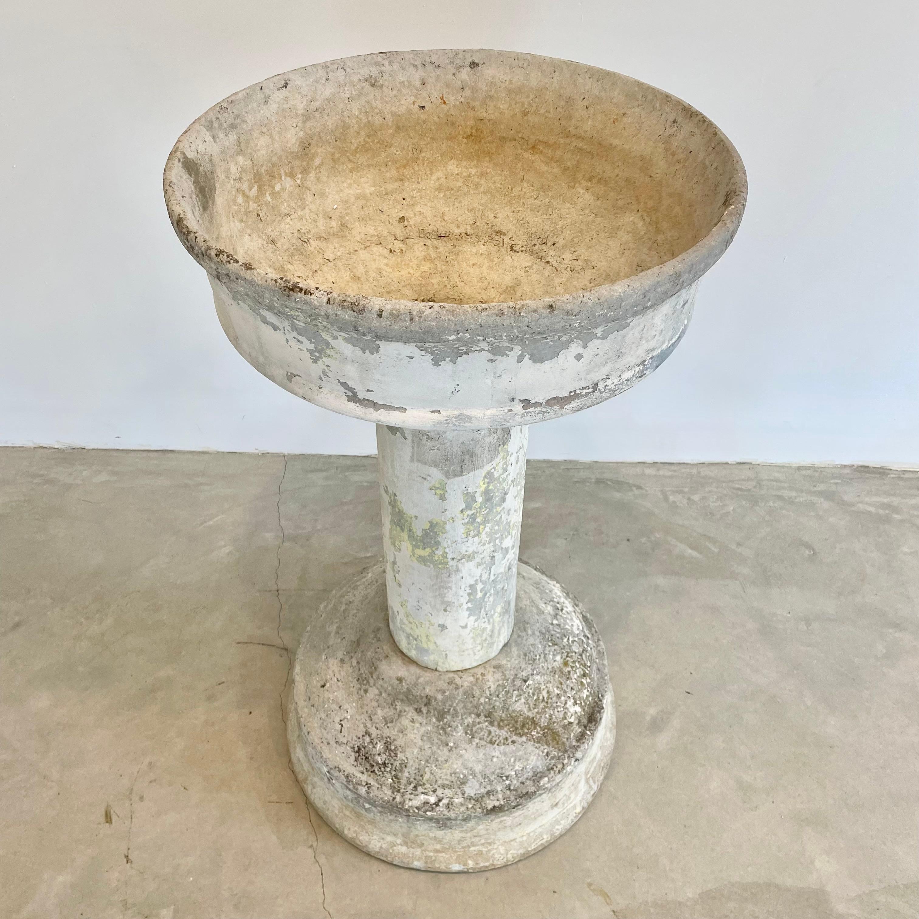 Massive and rare concrete fountain by Willy Guhl for Eternit. Fabricated out of three pieces of cement. Large basin on both ends with hollow cylinder connecting the two. Great sculpture and object. Bowl has factory drilled holes to allow water to