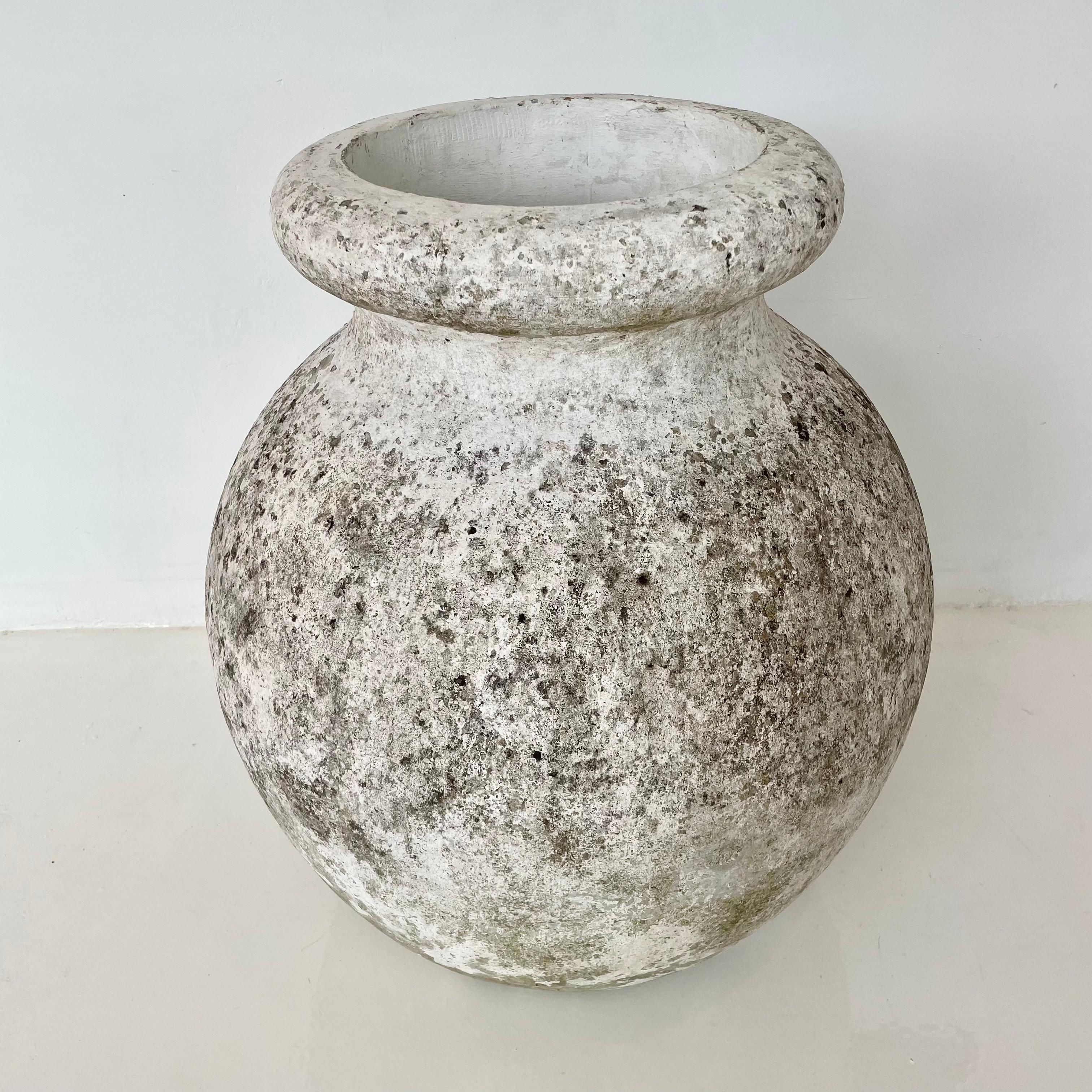 Gigantic concrete urn planter by Willy Guhl, with great patina and prominent presence. Simple and elegant design perfect for any garden or patio. Small drainage hole on the side pictured below.

Mouth opening measures 11.5