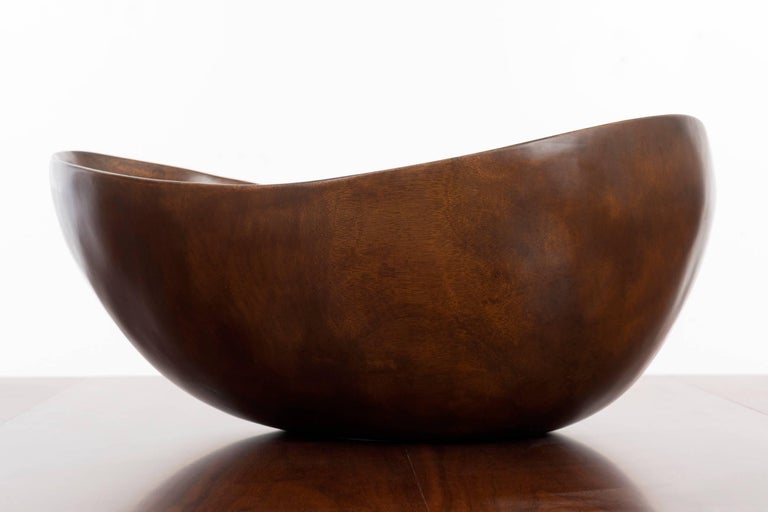 Woodworker Auld hand sculpts a large leaf like organic form in teakwood.
Small nature hairline fissure near top edge of bowl otherwise excellent original condition. 
[label on underside].
 